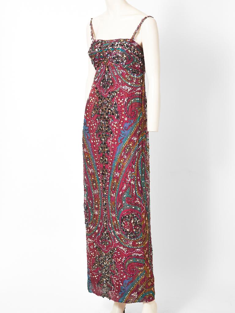Galanos, paisley pattern,  empire waist  chiffon gown, embellished with beads and sequins, having a slim body with spaghetti straps. The outer layer of the dress has a paisley pattern in a silk chiffon. The underpinning is a silk charmeuse in the