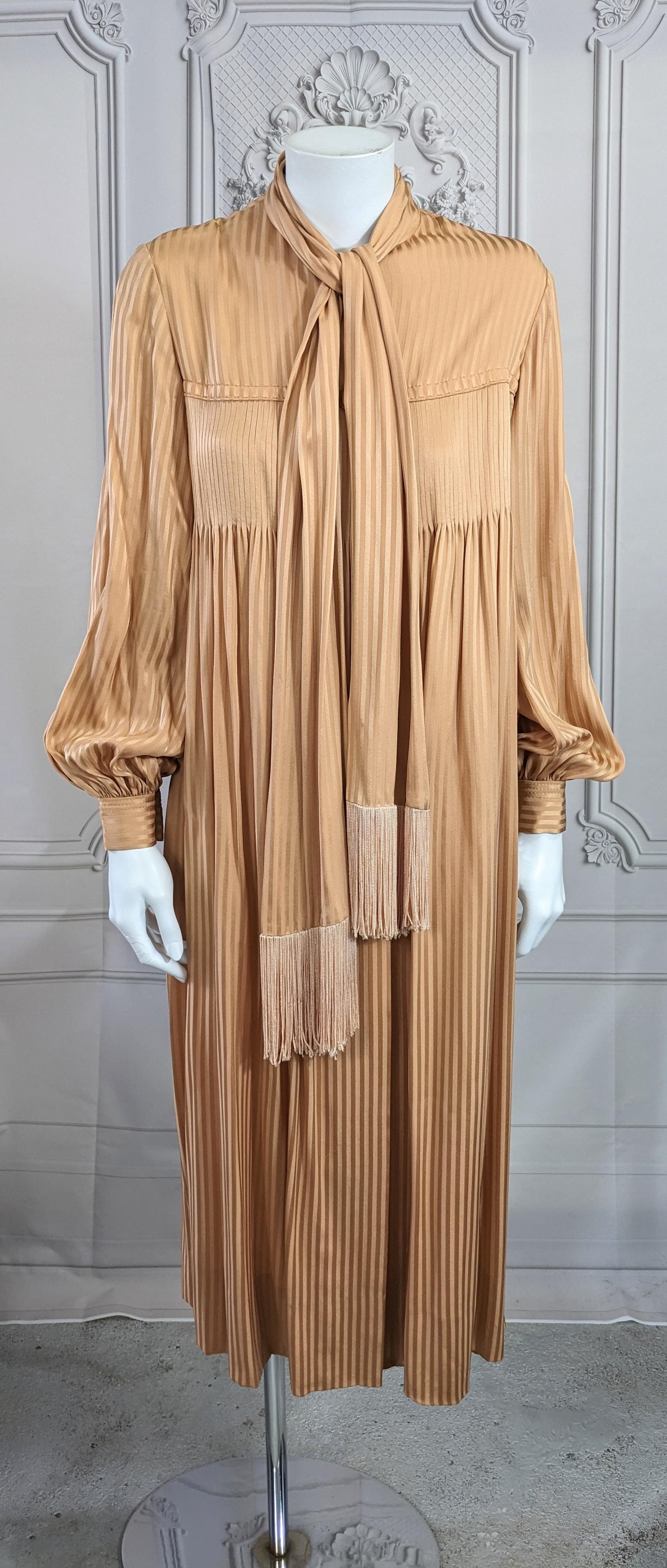 Galanos Silk Crepe Tucked Chemise with attached fringed scarf. Dozens of tiny pleats are stitched at bust and release into fullness below. Covered buttons down front with full sleeves. The exposed buttons are wood. Label missing. Lined in silk
