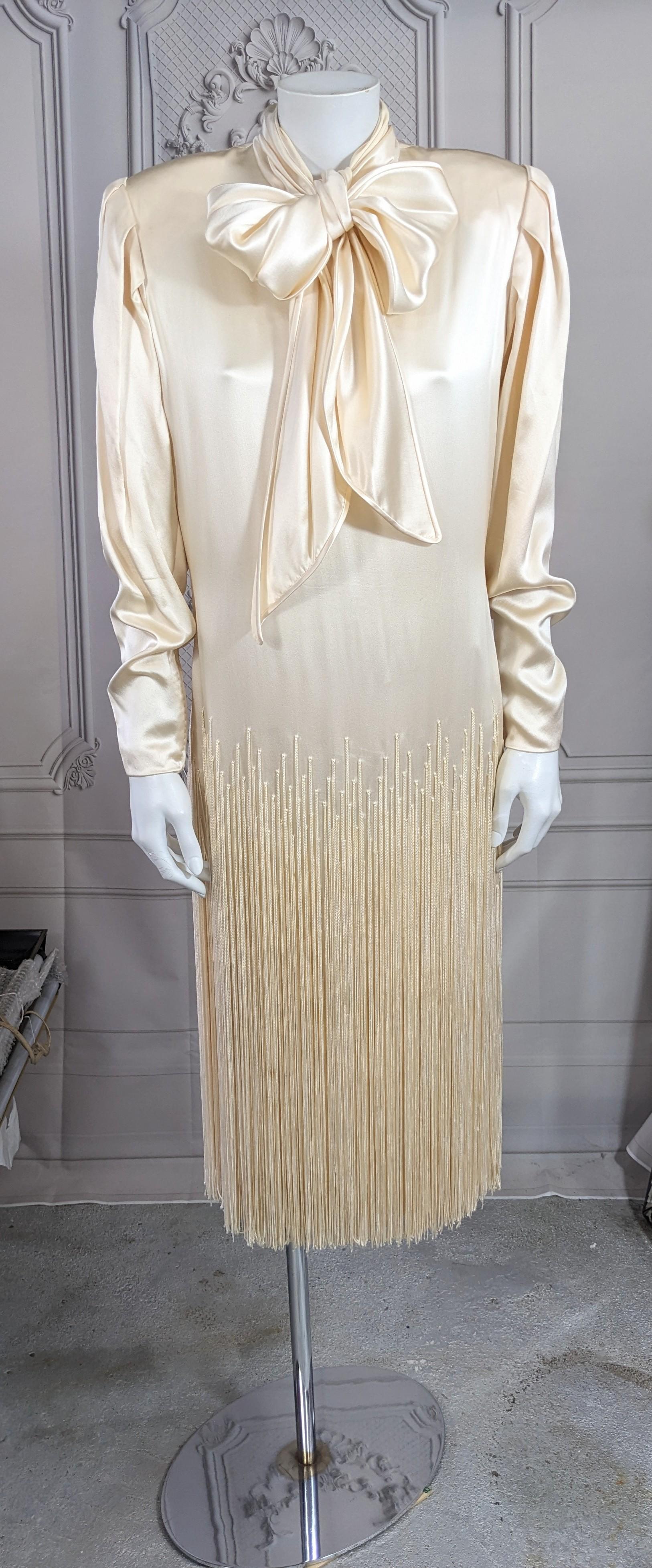 James Galanos Silk Satin Hand Fringed Dress from the 1980's. Silk satin with long sash tie collar, shoulder pads and hand fringing from the hip level down. Beautiful quality construction as to be expected with back and wrist zippers. Wonderful