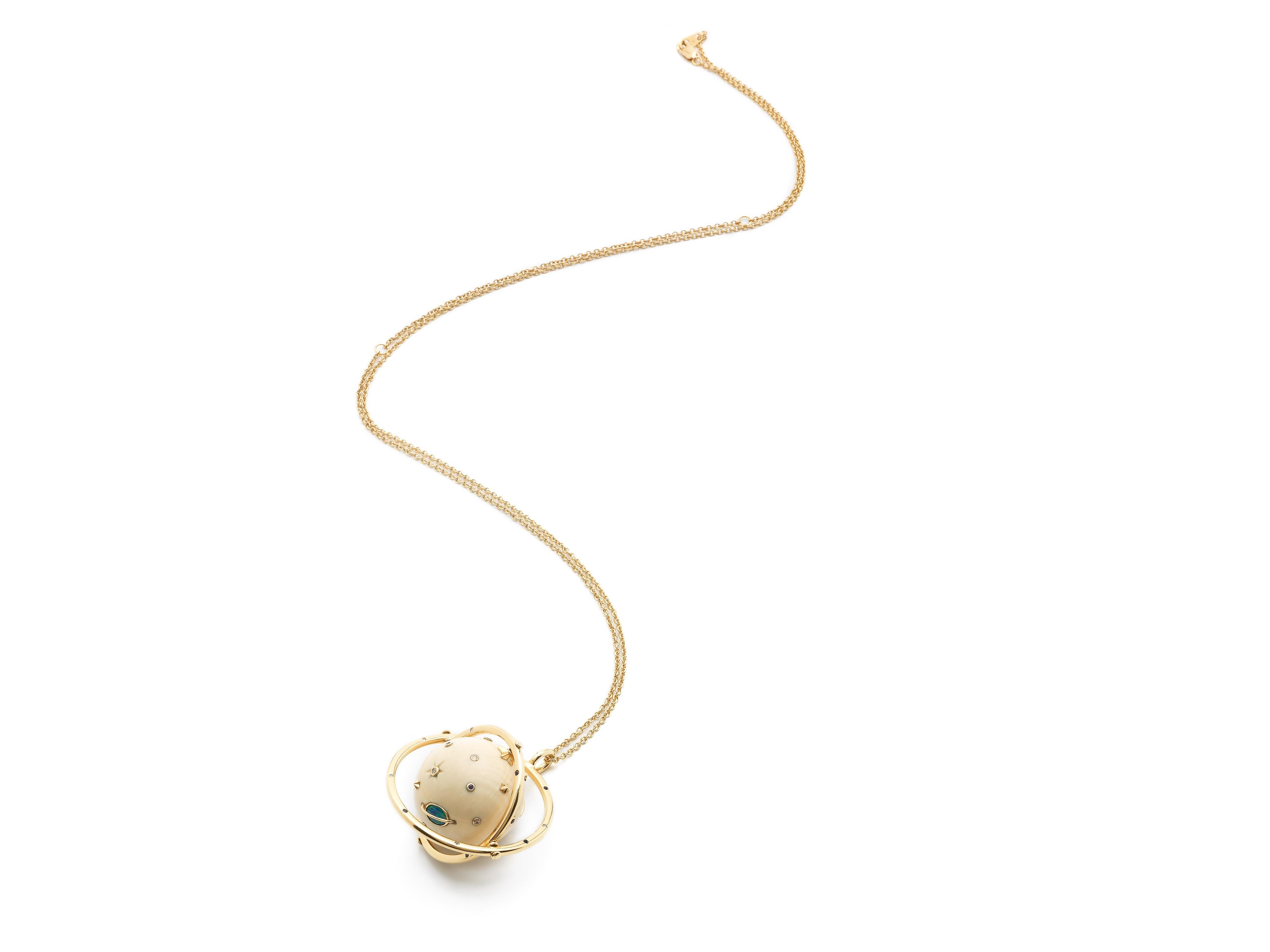In this striking pendant necklace, the mammoth tusk orb and the two 18k yellow gold rings that surround it all move within one another, making it an endlessly tactile, playful piece. The orb, carved from 60,000-year-old mammoth tusk, is embellished