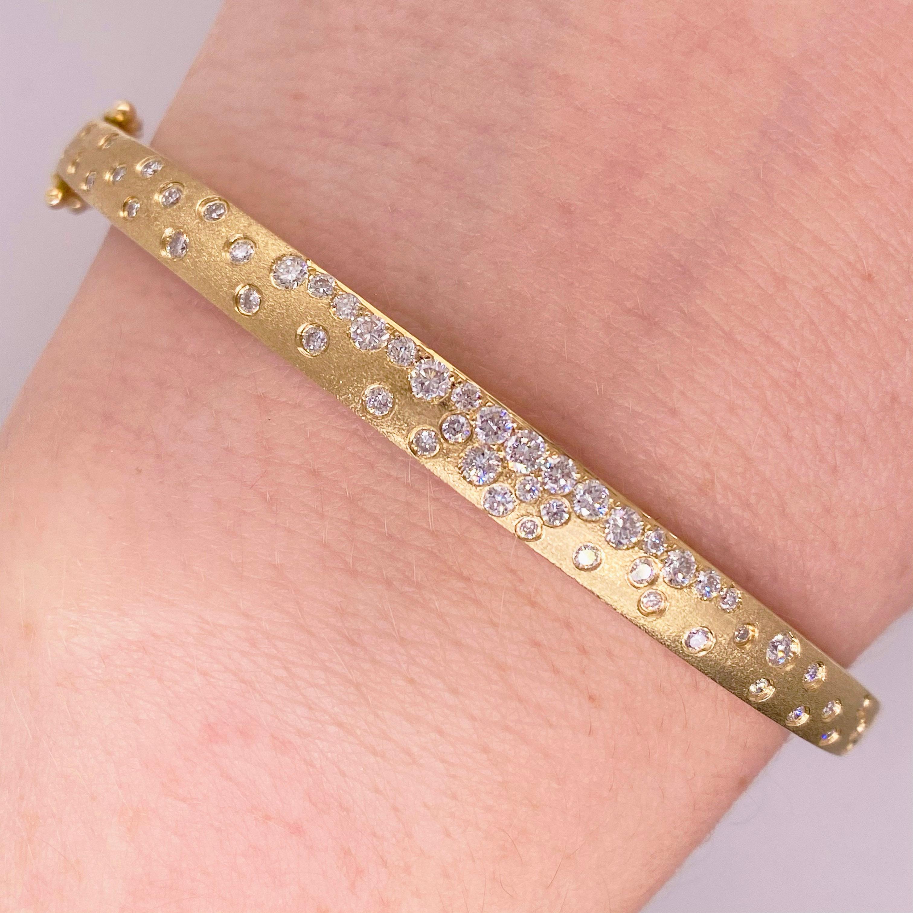 This Galaxy Diamond Bracelet has beautiful brushed gold with the diamonds all set flush.  The bangle bracelet has .83 carats of brilliant white diamonds set in brushed 14 karat yellow gold! This one of a kind piece is a cute addition to any fine