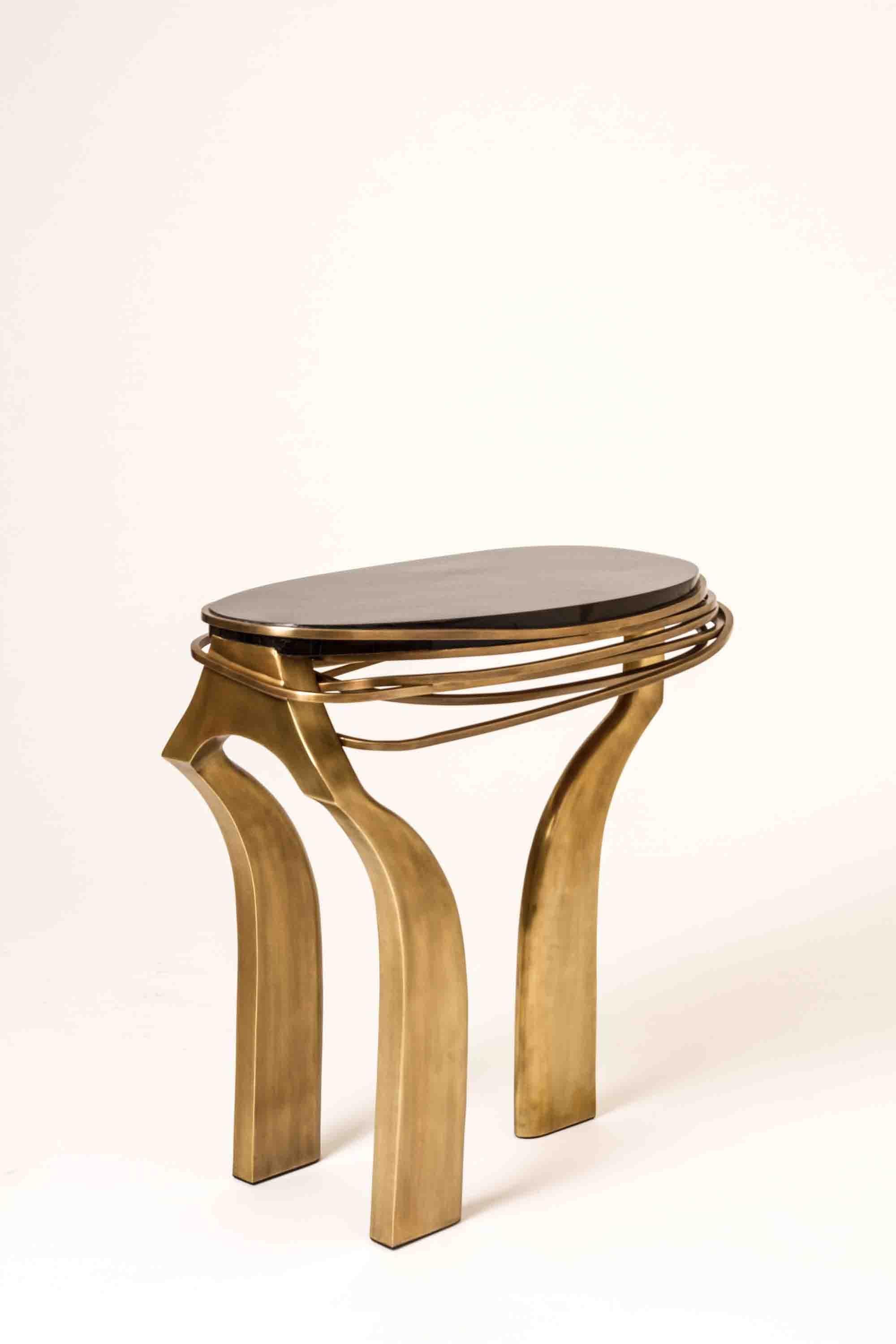 The Galaxy side table in Large is an iconic Kifu Paris piece. Whimsical, sculptural and bold this piece makes the ultimate accent piece in any space. The intricate bronze-patina brass rings encircle the black pen shell amorphous-shaped inlaid top.