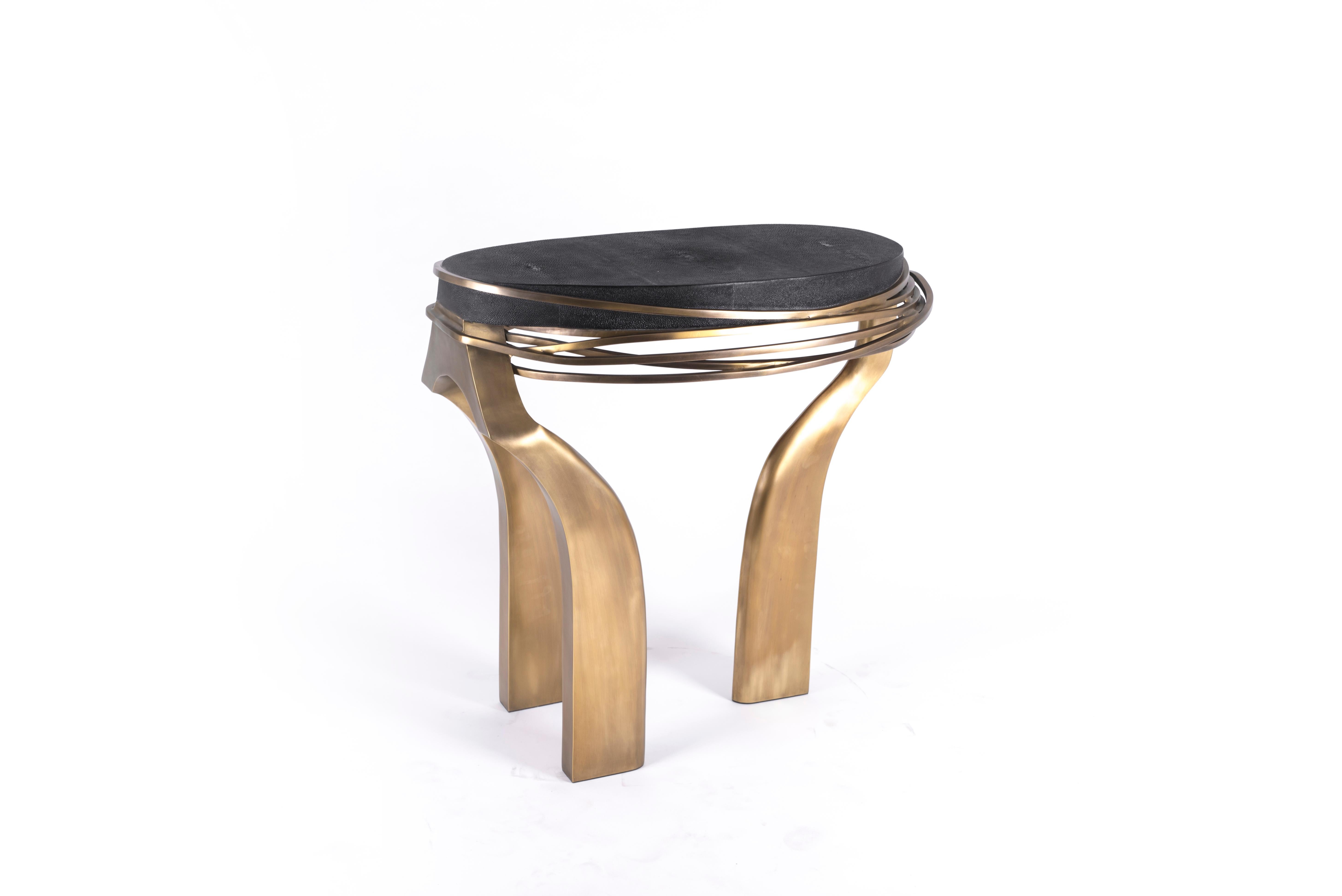 The galaxy side table in Large is an iconic Kifu Paris piece. Whimsical, sculptural and bold this piece makes the ultimate accent piece in any space. The intricate bronze-patina brass rings encircle the coal black shagreen amorphous-shaped inlaid