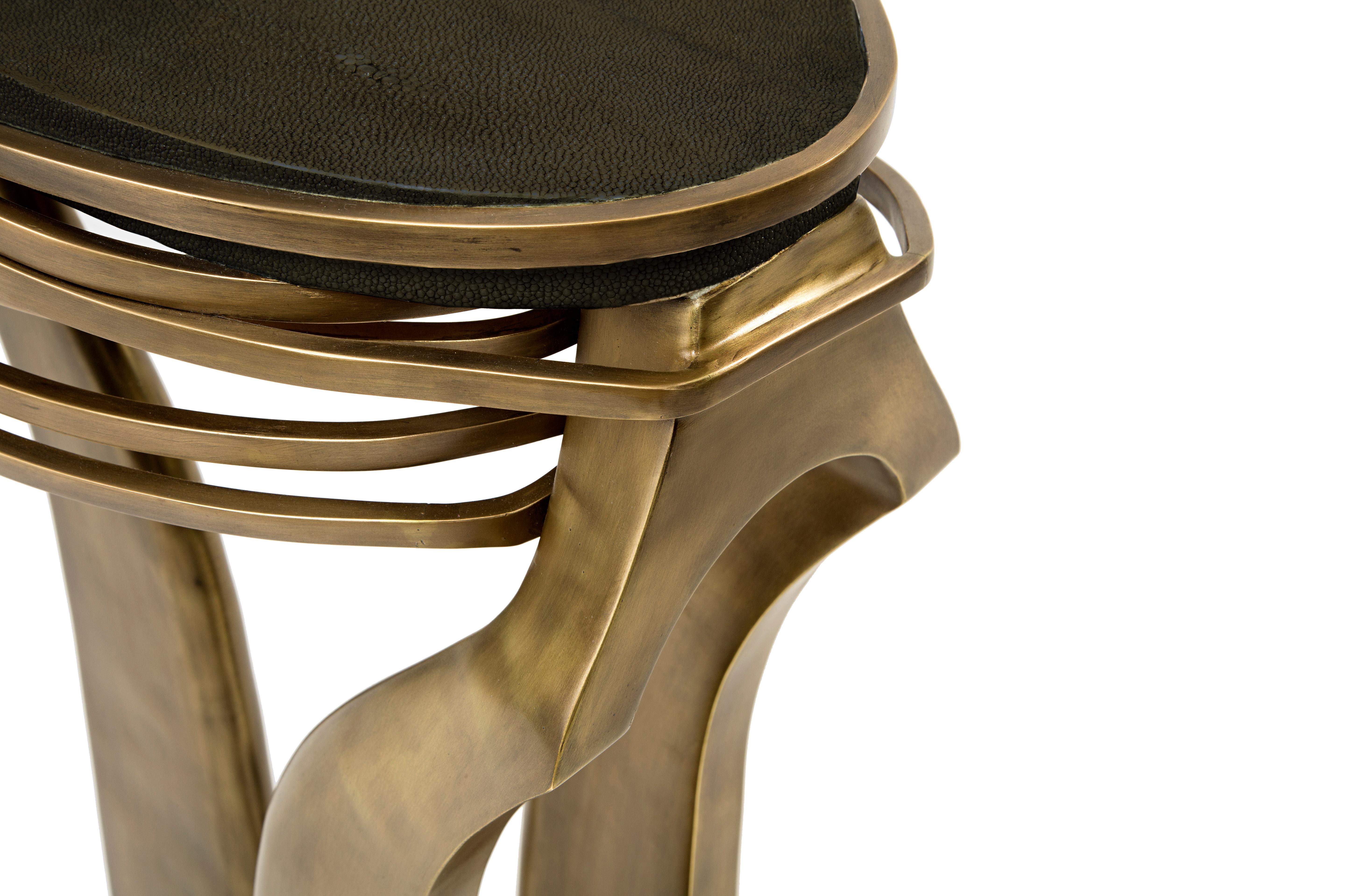 The galaxy side table in small is an iconic Kifu Paris piece. Whimsical, sculptural and bold this piece makes the ultimate accent piece in any space. The intricate bronze-patina brass rings encircle the black shagreen amorphous-shaped inlaid top.