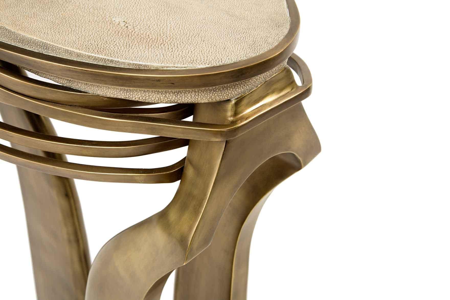 The galaxy side table in small is an iconic Kifu Paris piece. Whimsical, sculptural and bold this piece makes the ultimate accent piece in any space. The intricate bronze-patina brass rings encircle the cream shagreen amorphous-shaped inlaid top.