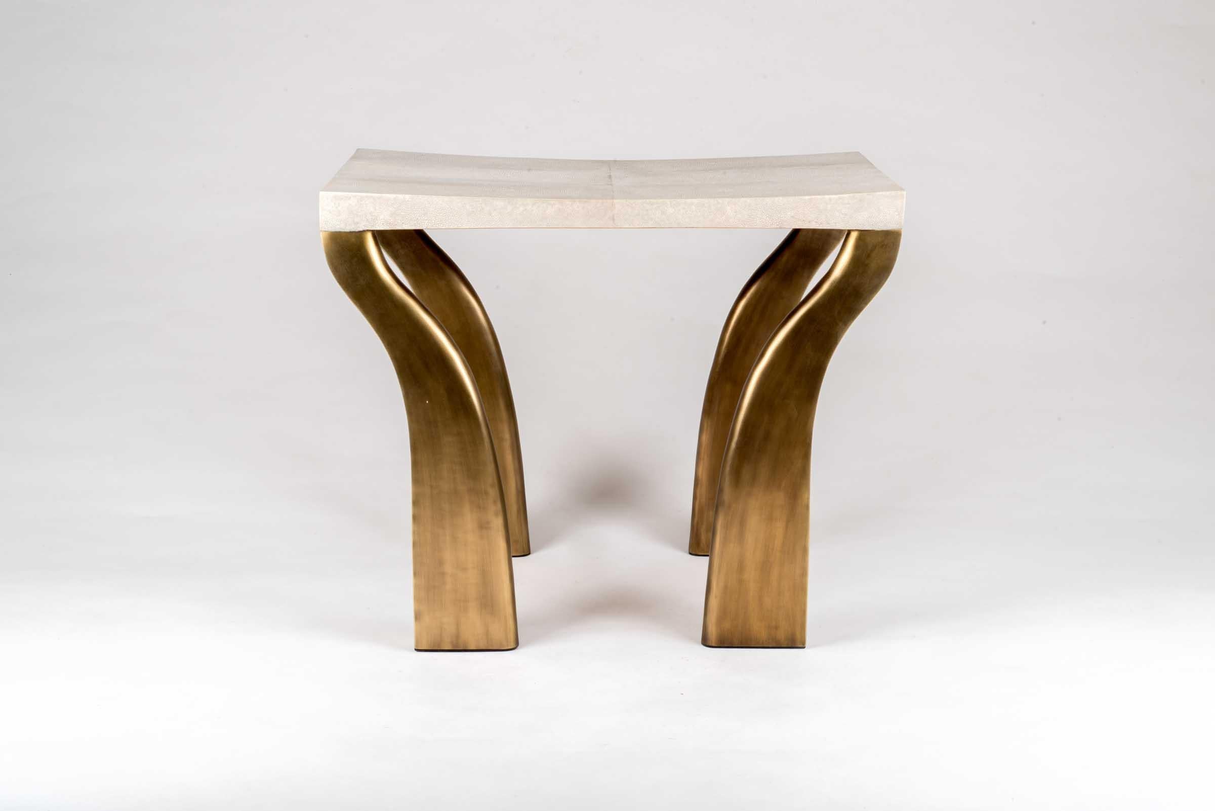 The galaxy writing desk stool in cream shagreen, is a sculptural and sleek piece with its beautiful bronze-patina brass legs. This piece was designed to be paired with the beautiful galaxy writing Desk, see image at end of slide. The shagreen is