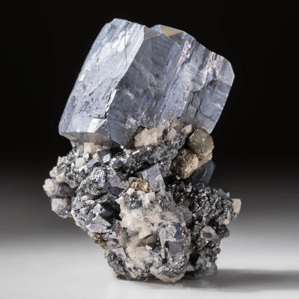 From Joplin, Jasper County, Missouri, USA
Lustrous large single 1 inch blue steel colored galena crystals on matrix enriched with quartz and yellow-metallic pyrite crystals. The galena is fully terminated with octahedral faces at the