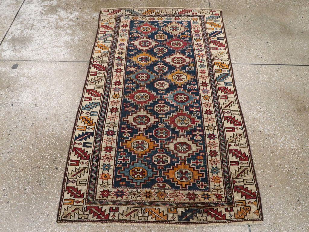 An antique Caucasian Shirvan throw rug. From the eastern Caucasus regardless. Two columns of small. Stepped lozenge medallions with octagon and crosshatch centers stand out on the dark blue ground with a central column of en suite octagons between.
