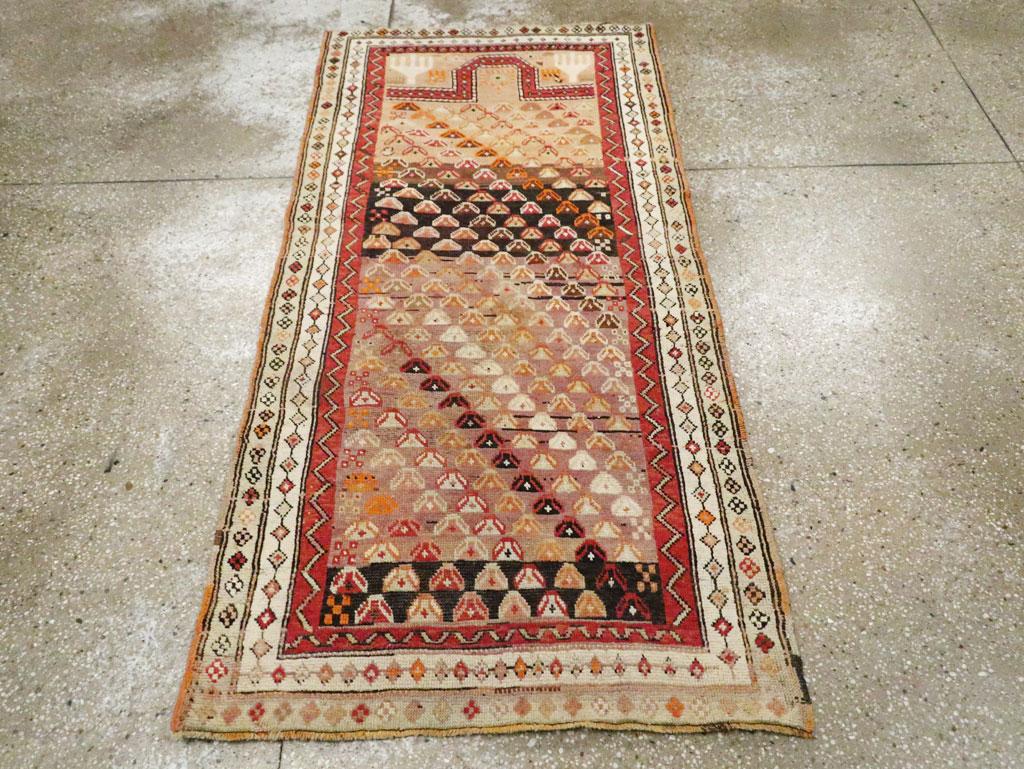 This early 20th century Caucasian rug, measuring 2' 9