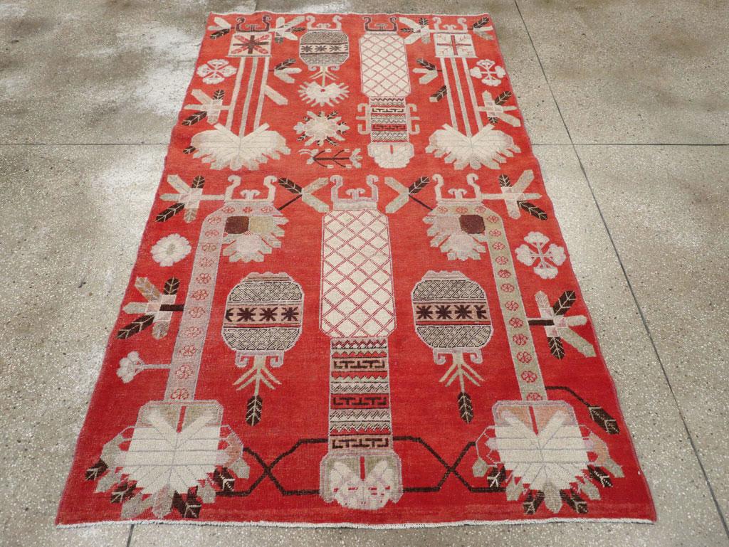 An antique East Turkestan pictorial vase Khotan rug handmade during the early 20th century.

Measures: 4' 9