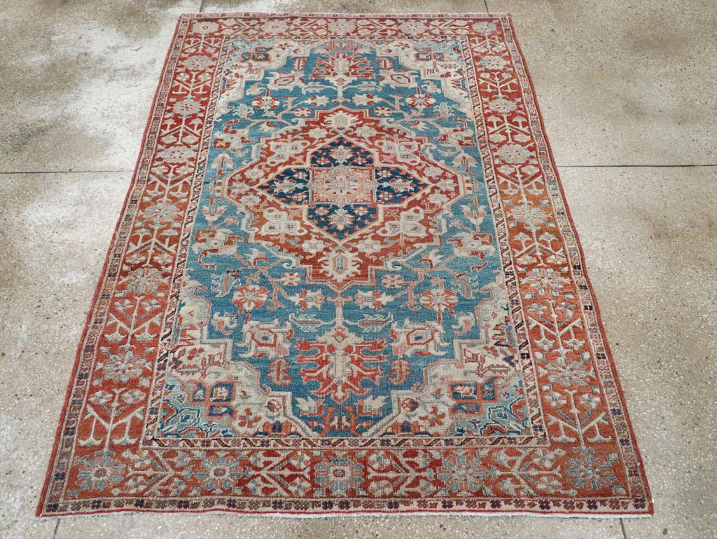 An antique Persian Heriz accent rug handmade during the early 20th century.

Measures: 5' 5