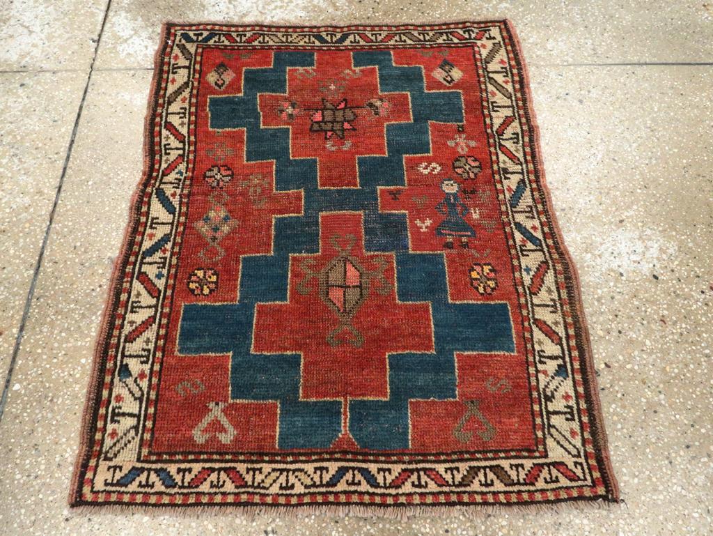 An antique Persian Kurdish throw rug handmade during the Early 20th century.

Measures: 2' 5