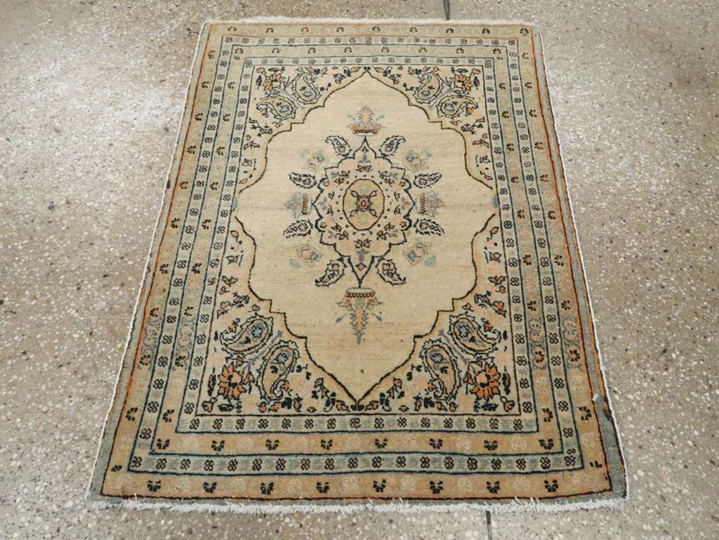 This early 20th-century Persian Tabriz Hagi Jalili rug, measuring 1'11