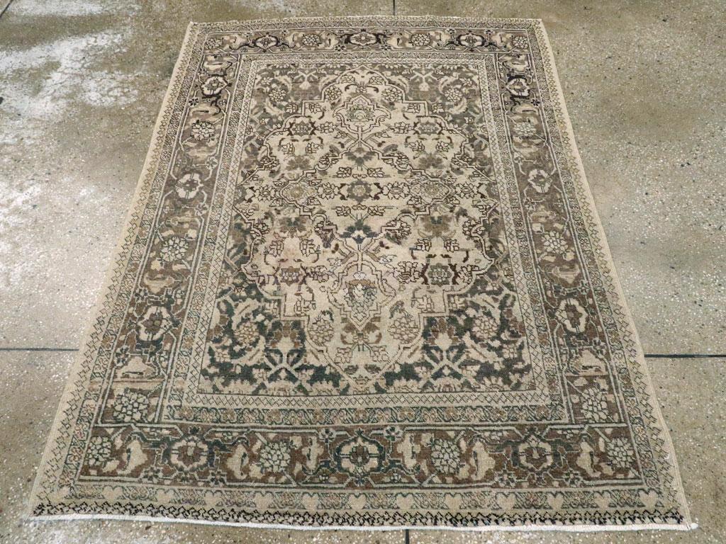 This Early 20th century Persian Tabriz rug, measuring 4' 1