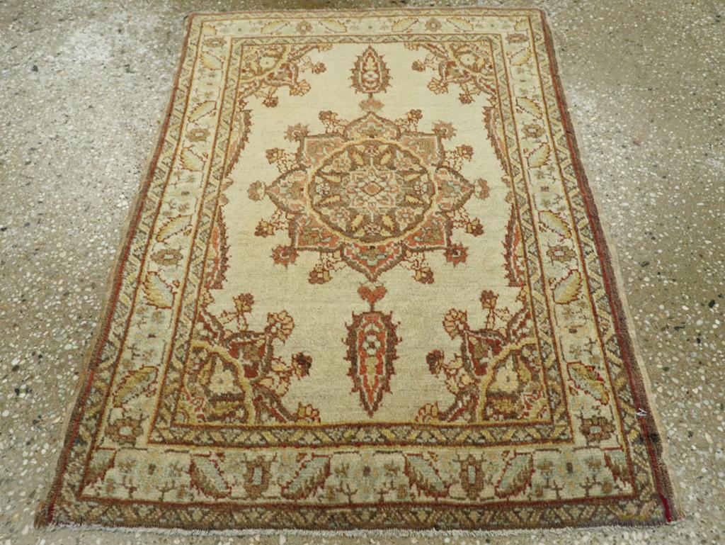 This Early 20th century Persian Tabriz rug, measuring 1'10