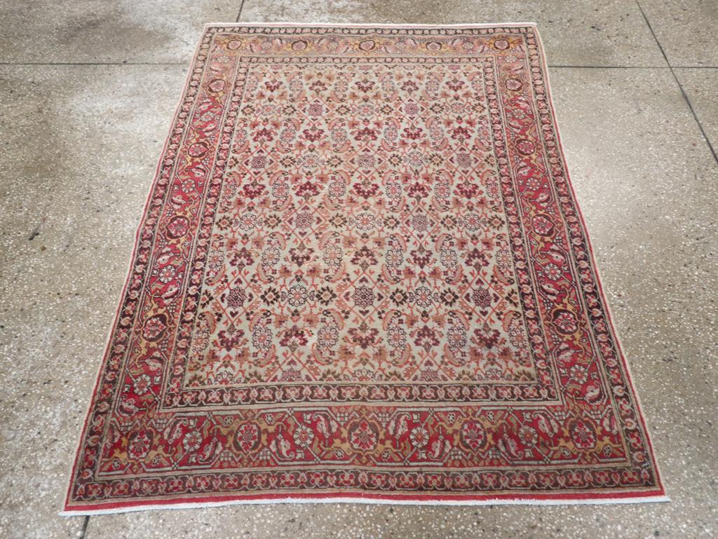 This Early 20th century Persian Tabriz rug, measuring 3' 9