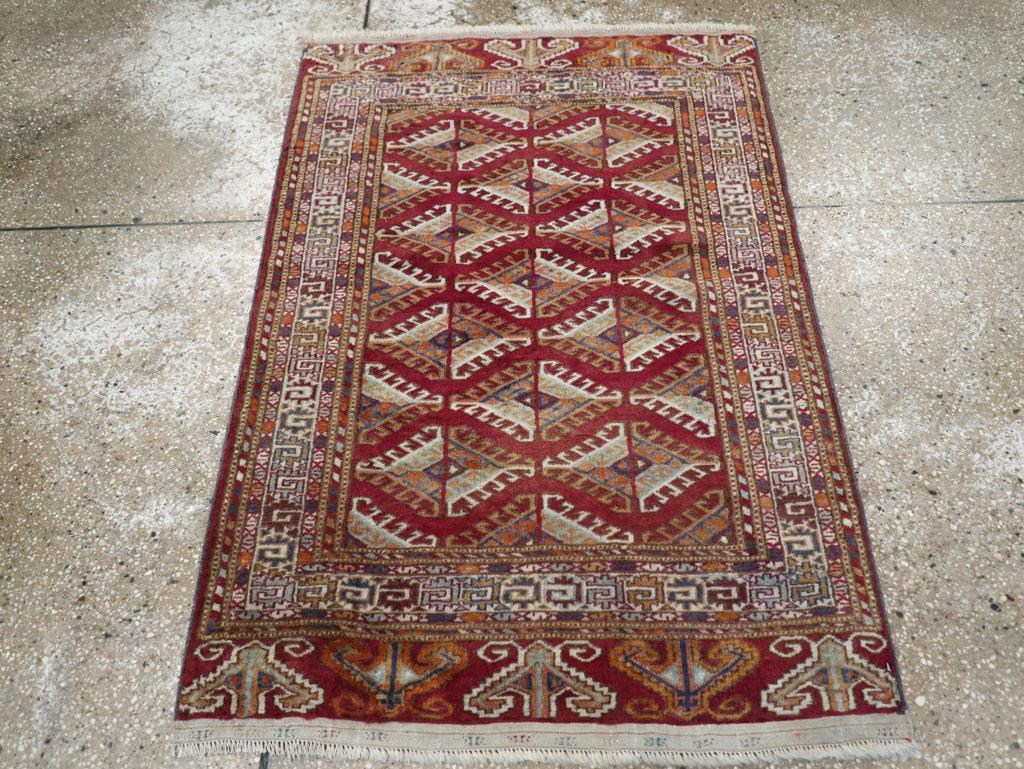 A vintage Central Asian Tekke throw rug handmade during the Mid-20th century.

Measures: 2' 9