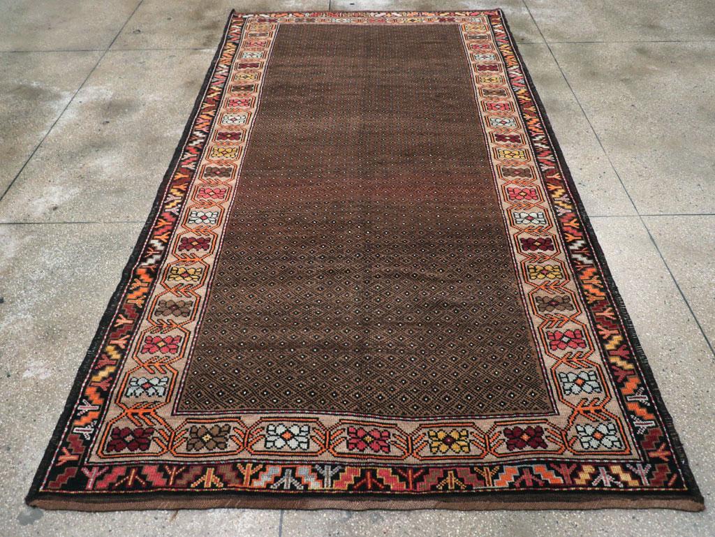 A vintage Turkish Anatolian tribal gallery carpet handmade during the Mid-20th Century.

Measures: 6' 4