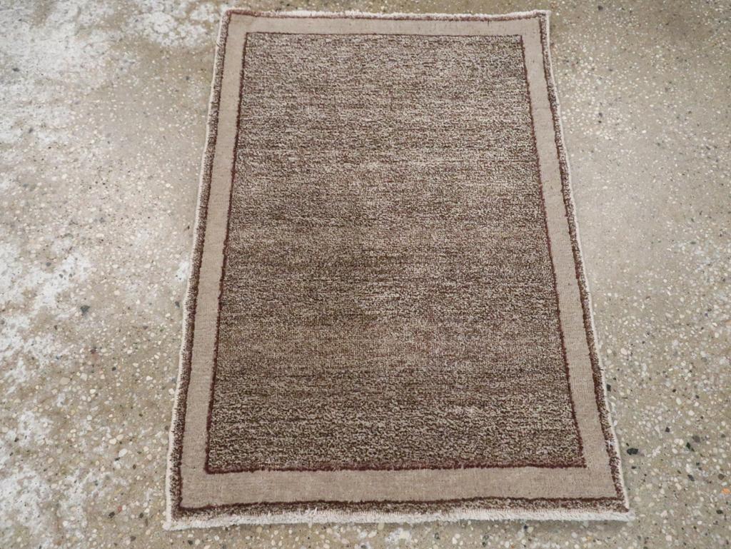 This mid-20th-century Persian Mashad rug, measuring 1' 8