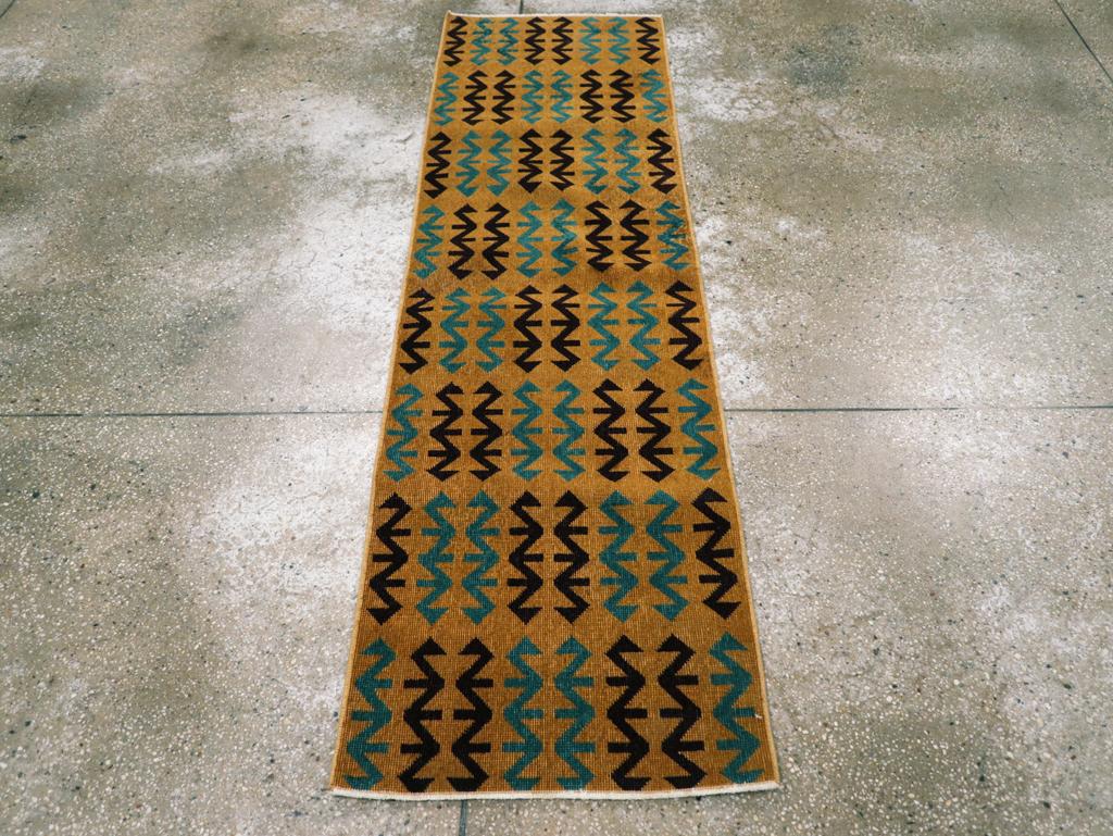 This striking mid-20th century Turkish Anatolian Deco runner, measuring 1' 11