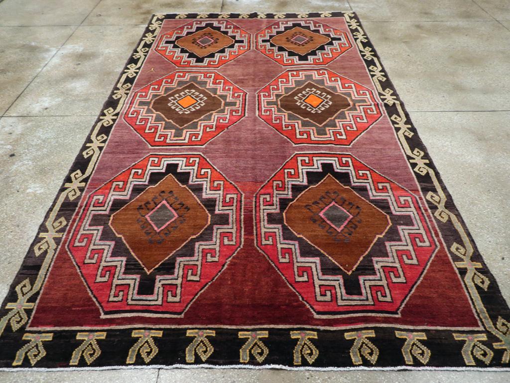 This striking mid-20th century Turkish Anatolian tribal room-size carpet, measuring 7' 2
