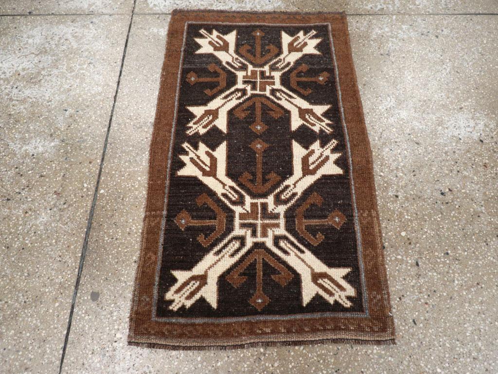 This Mid-20th century Turkish Anatolian rug, measuring 1' 10