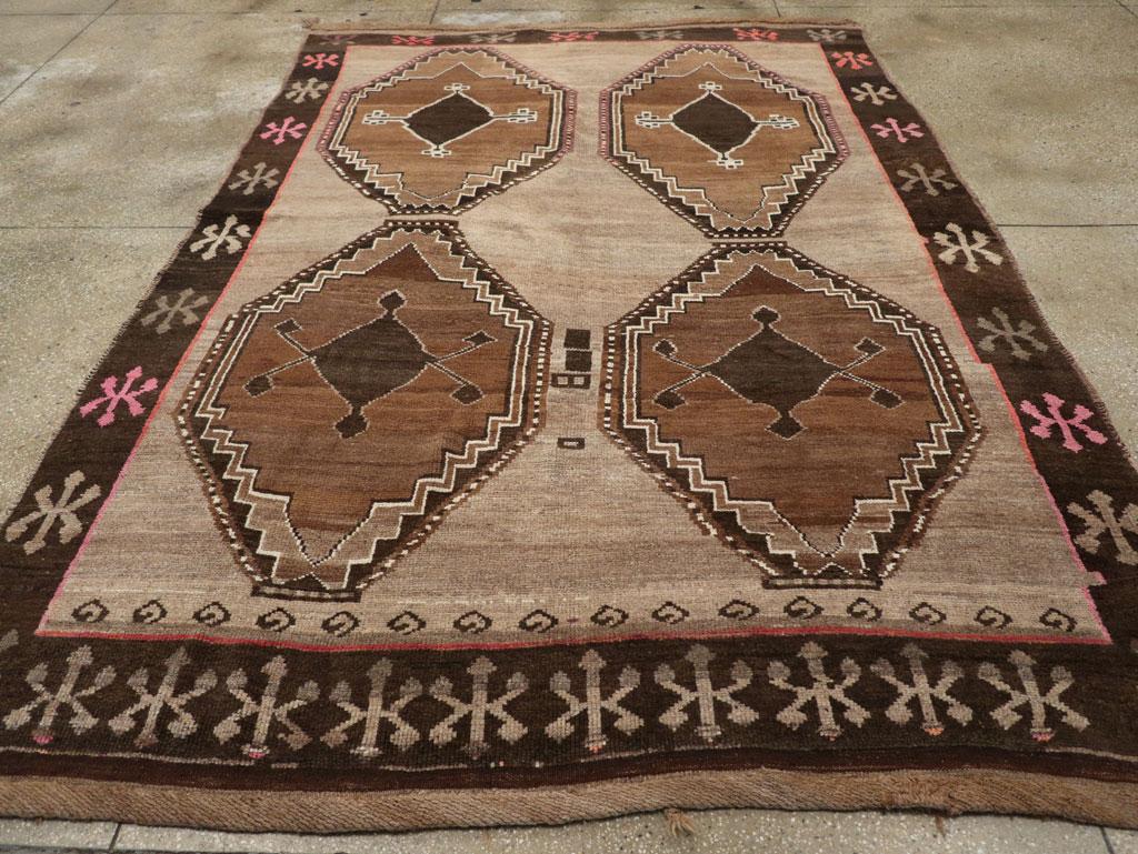 This mid-20th century Turkish Anatolian tribal carpet, measuring 7' 5