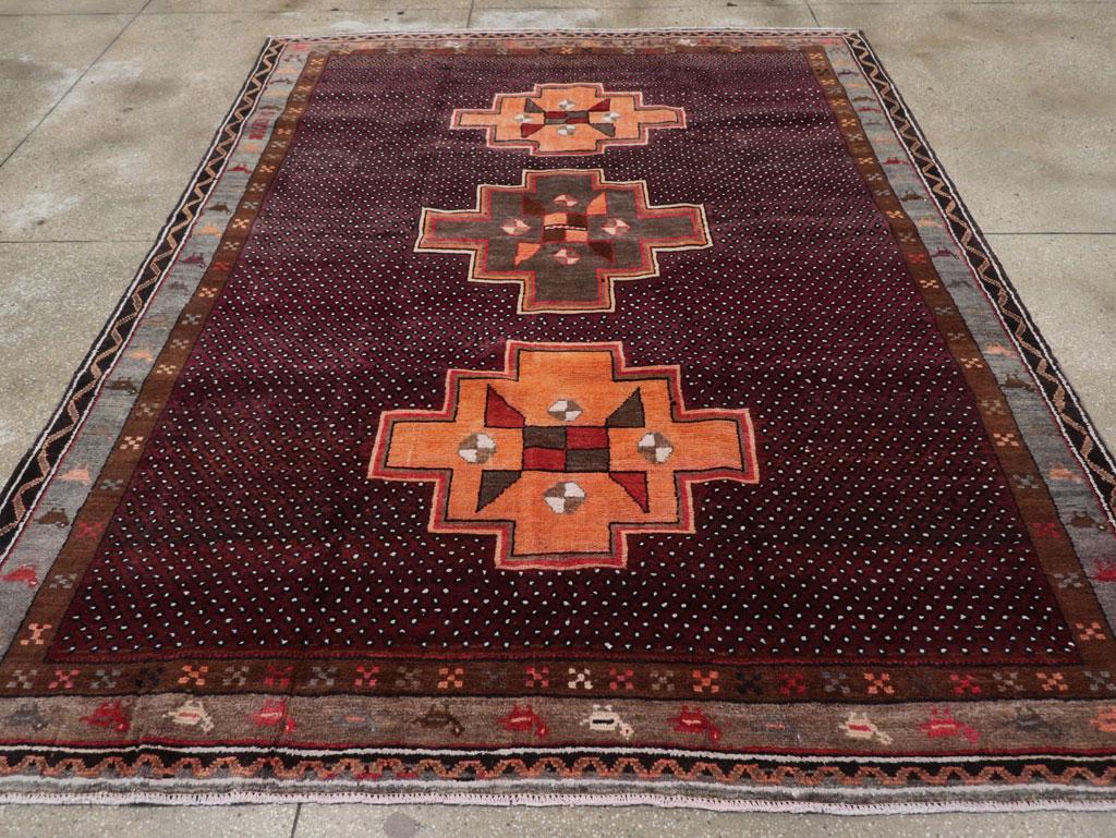 This mid-20th century Turkish Anatolian tribal carpet, measuring 7' 9