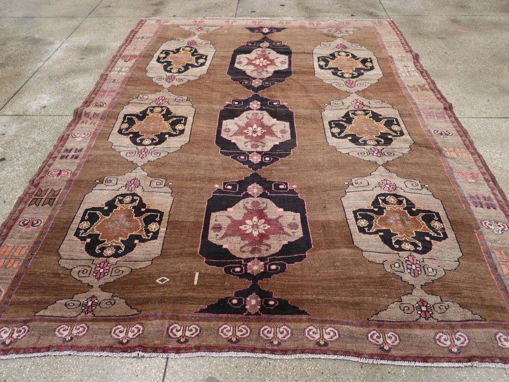 This mid-20th century Turkish Anatolian tribal carpet, measuring 7' 11