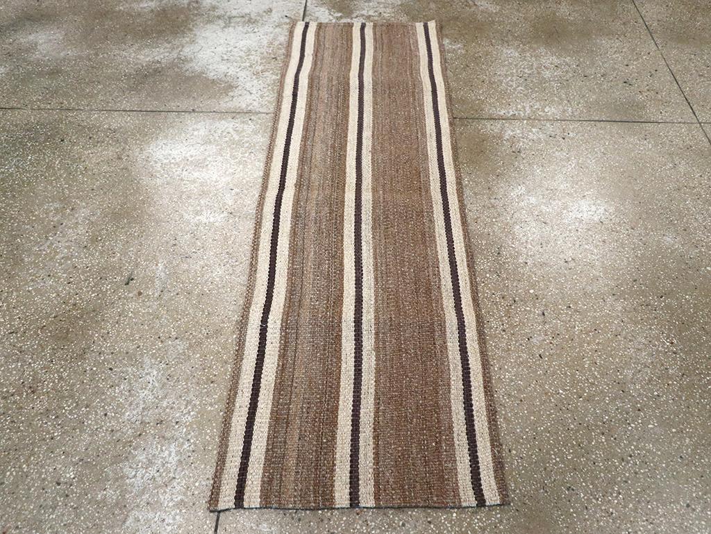 This mid-20th century Turkish flatweave kilim runner, measuring 2' 0