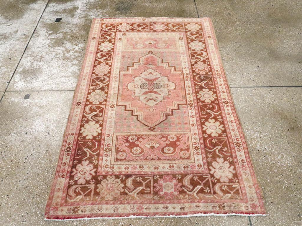 This mid-20th century Turkish Oushak rug, measuring 3' 5