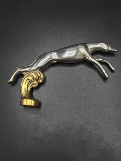 "Galgo" dog car mascot in mixed colors, from the 1960s