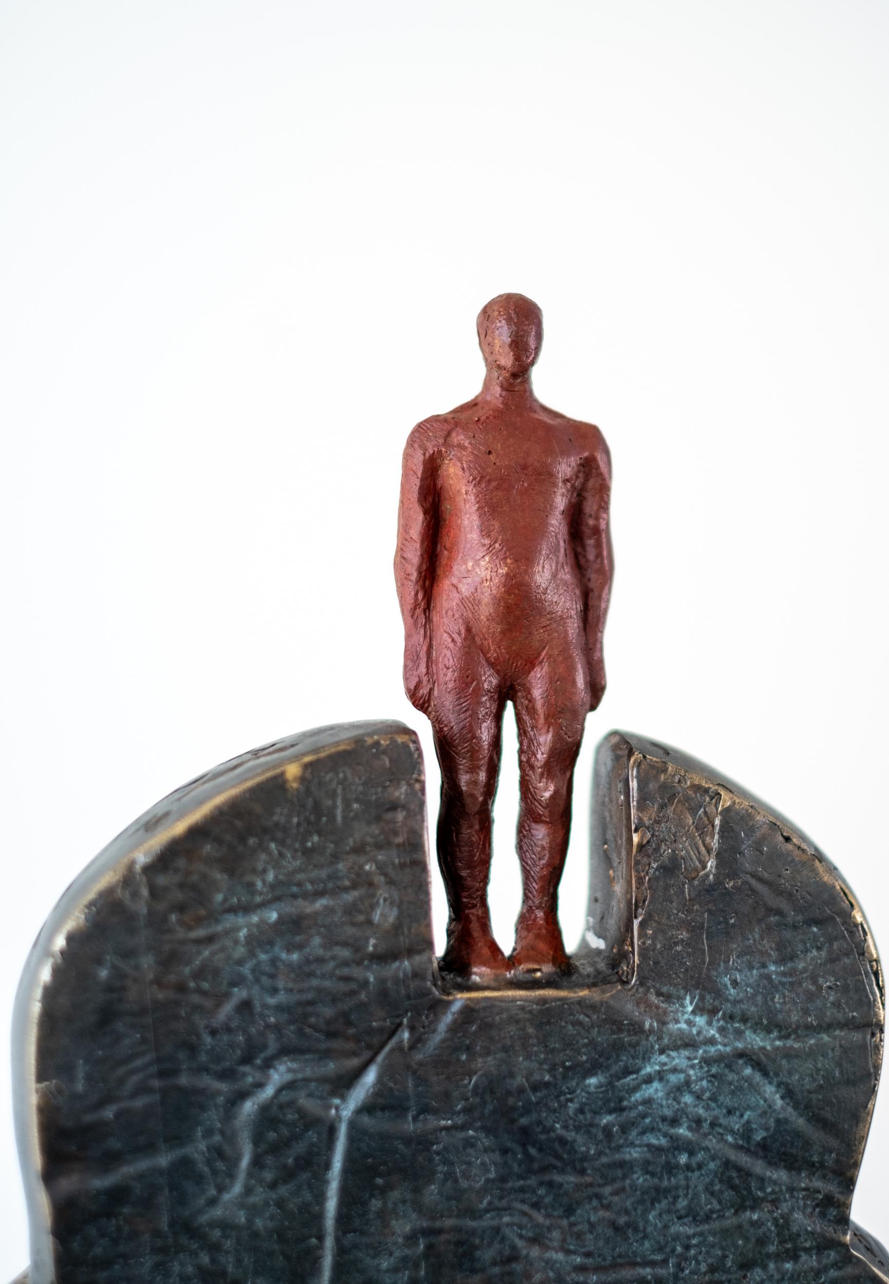 Forged from bronze, this contemporary figurative indoor sculpture was made by Galina Stetco. The silhouette of a human bust has a hole where the heart is located and a metal ladder covers the hole that leads to the head. The ladder is designed to