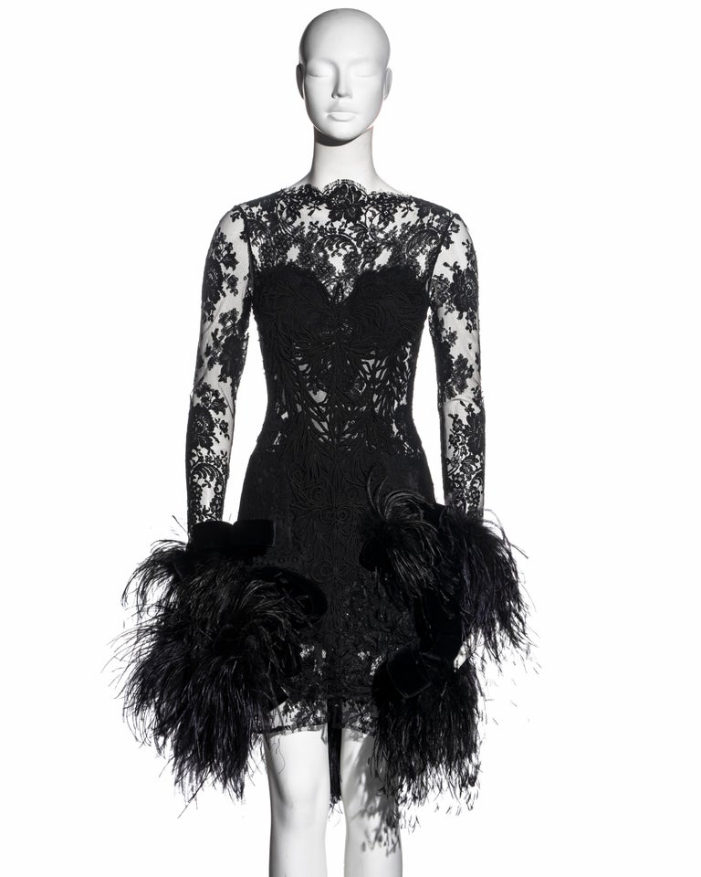 ▪ Galitzine Couture black lace evening dress 
▪ Ostrich feather skirt with black velvet bow appliqués 
▪ Built-in cups 
▪ Size approx. FR 38 - UK 10 - US 6
▪ c. 1980
▪ Made in Italy