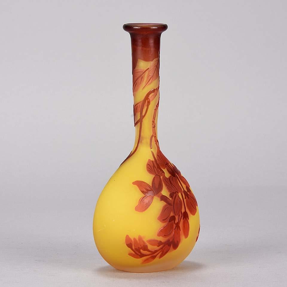 An excellent late 19th century French Art Nouveau vase of banjo form, with a deep red flowering landscape etched and acid cut against a yellow background, with fine color and detail, signed Gallé.