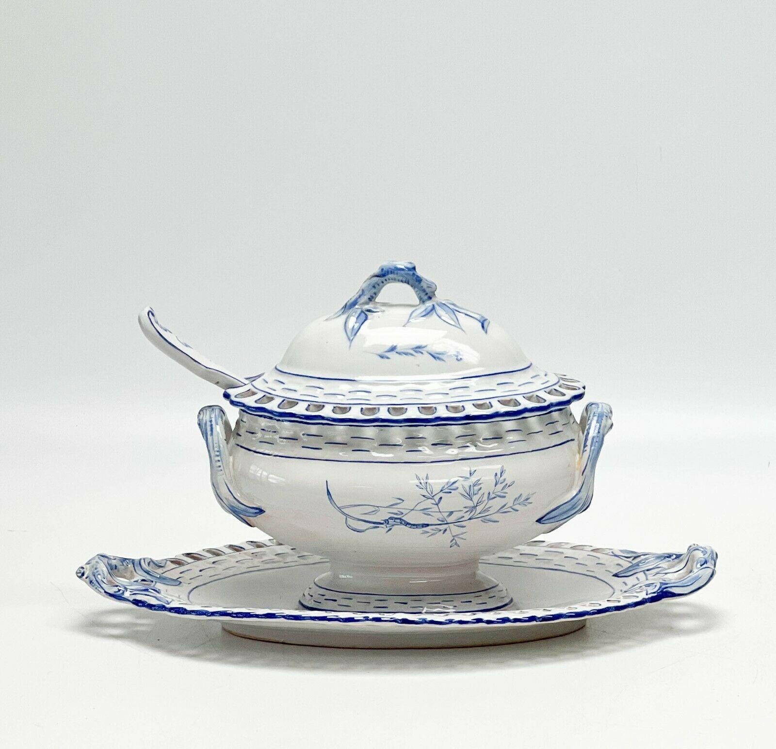 Galle Faience France Reticulated Porcelain Lidded Sauce Tureen with Assoc Spoon

circa 1880. A white ground with blue accents, floral and insect decoration. A reticulated rim, with associated slotted spoon. Underside with Galle marks.