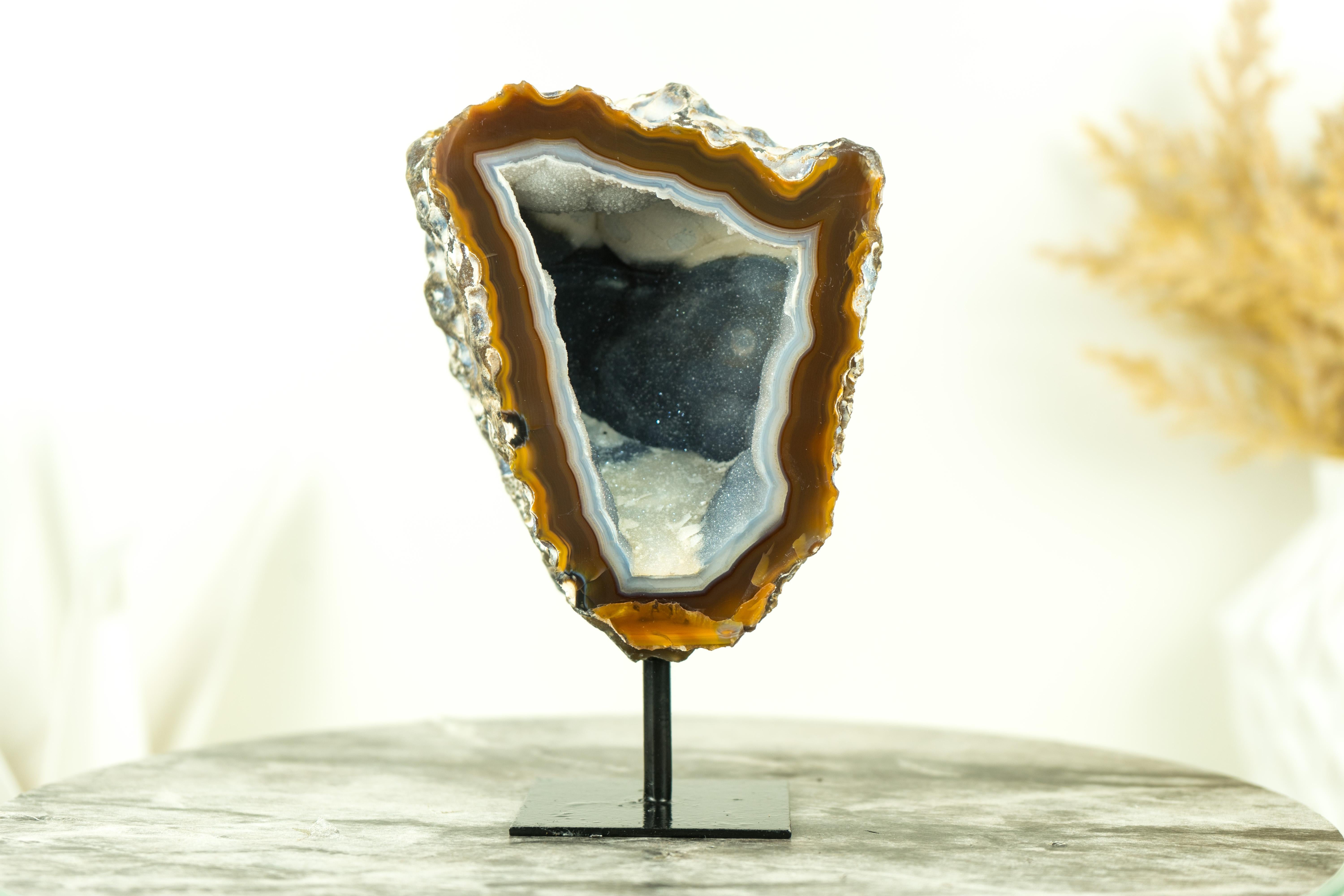 This unique, small agate geode displays gallery-grade formation as well as a rare color combination of Amber and White laces. A top-tier specimen, it's perfect for your gallery shelf or as a standout addition to your table that will leave friends in
