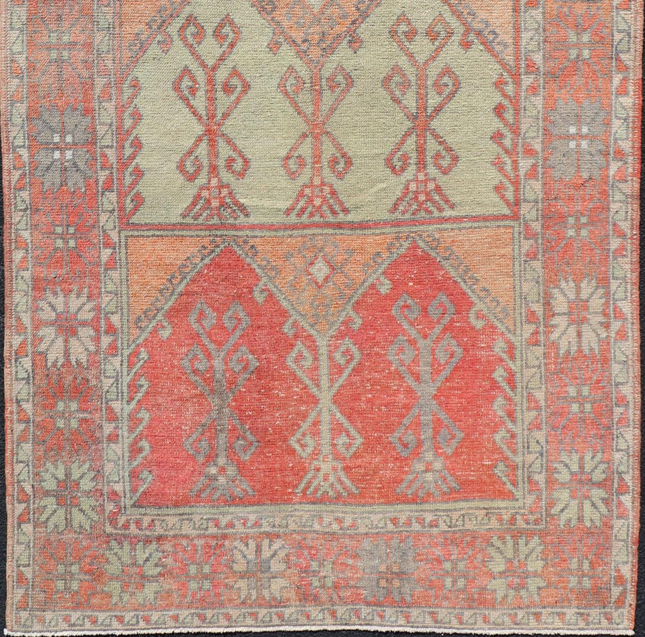 Hand-Knotted Gallery Rug, Vintage Turkish in Faded Red, Coral, Orange, Soft Pink and Green For Sale
