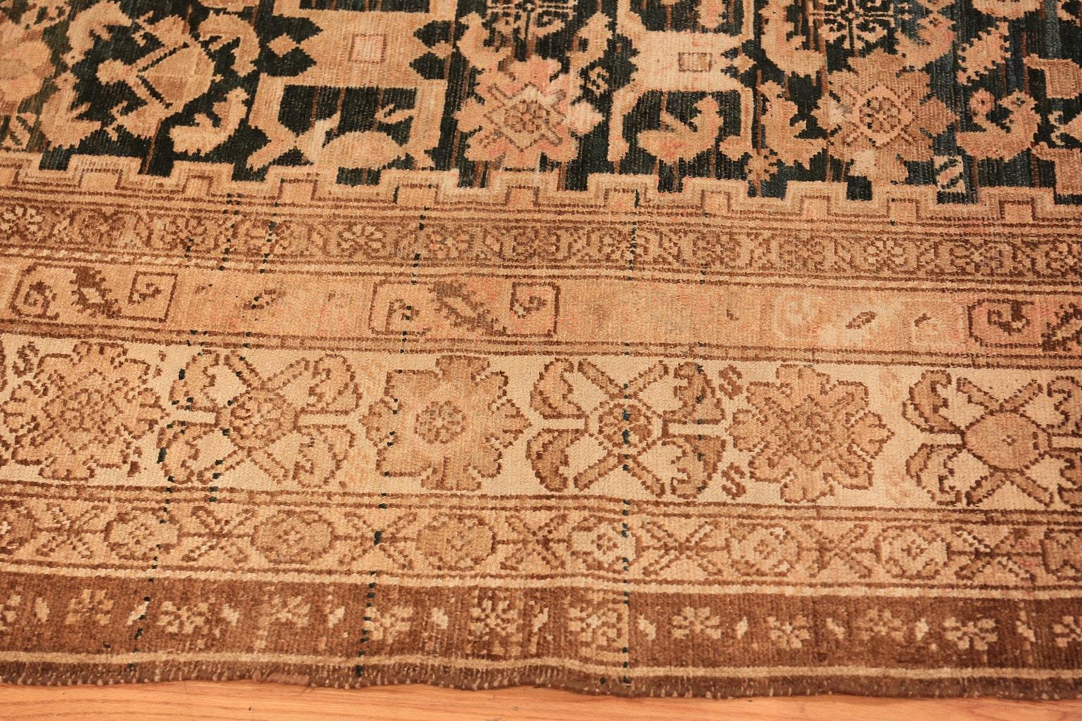 Tribal gallery size antique Persian Malayer rug, country of origin: Persia, date circa 1900. Size: 7 ft x 15 ft 7 in (2.13 m x 4.75 m).

This antique Persian rug is a long banner with an almost black central field that draws the eye. Created in the