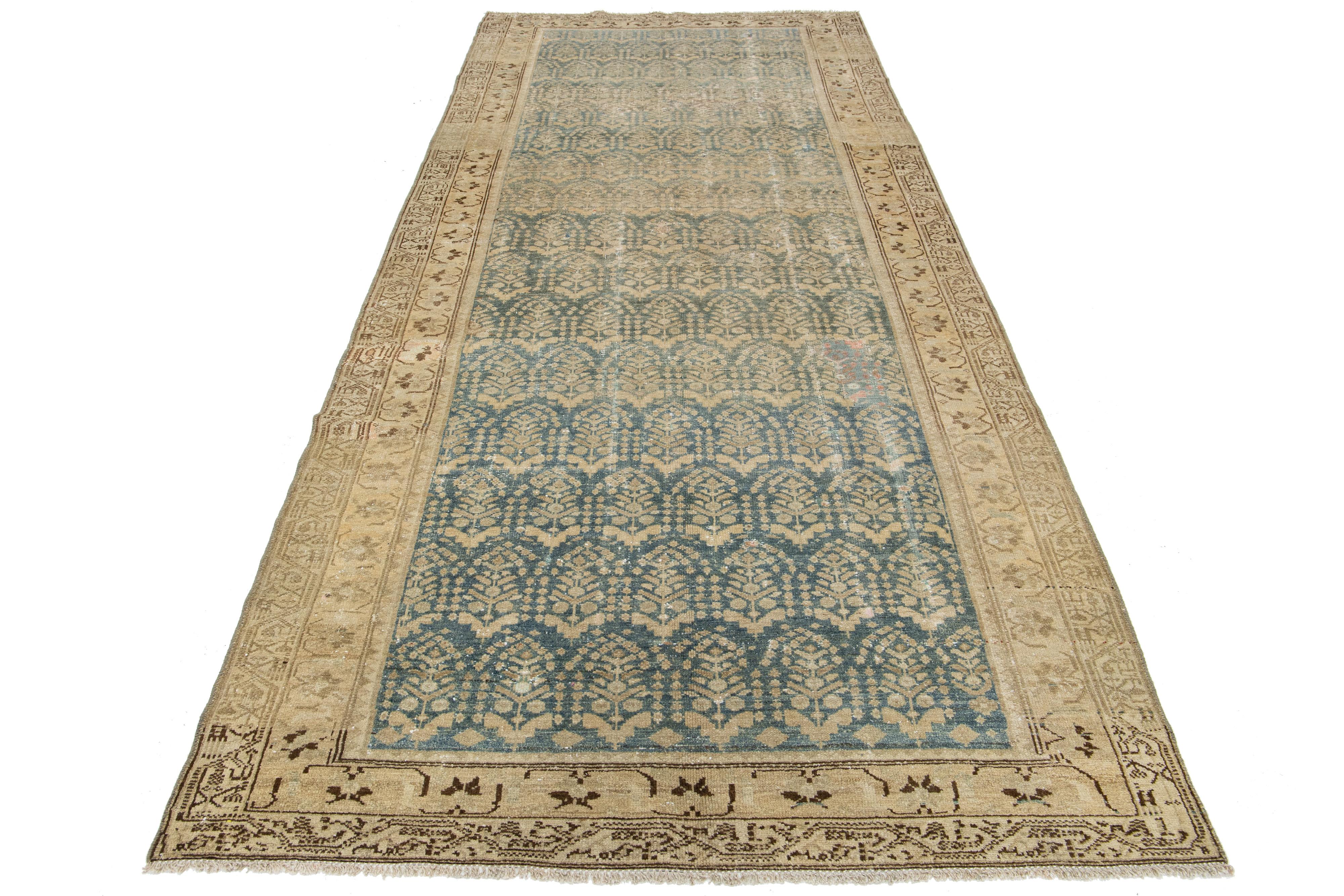 Antique 19th-century handmade Persian Malayer wool rug. This gallery-size rug has a blue field with beige and brown accents all over the design.

This rug measures 5'2
