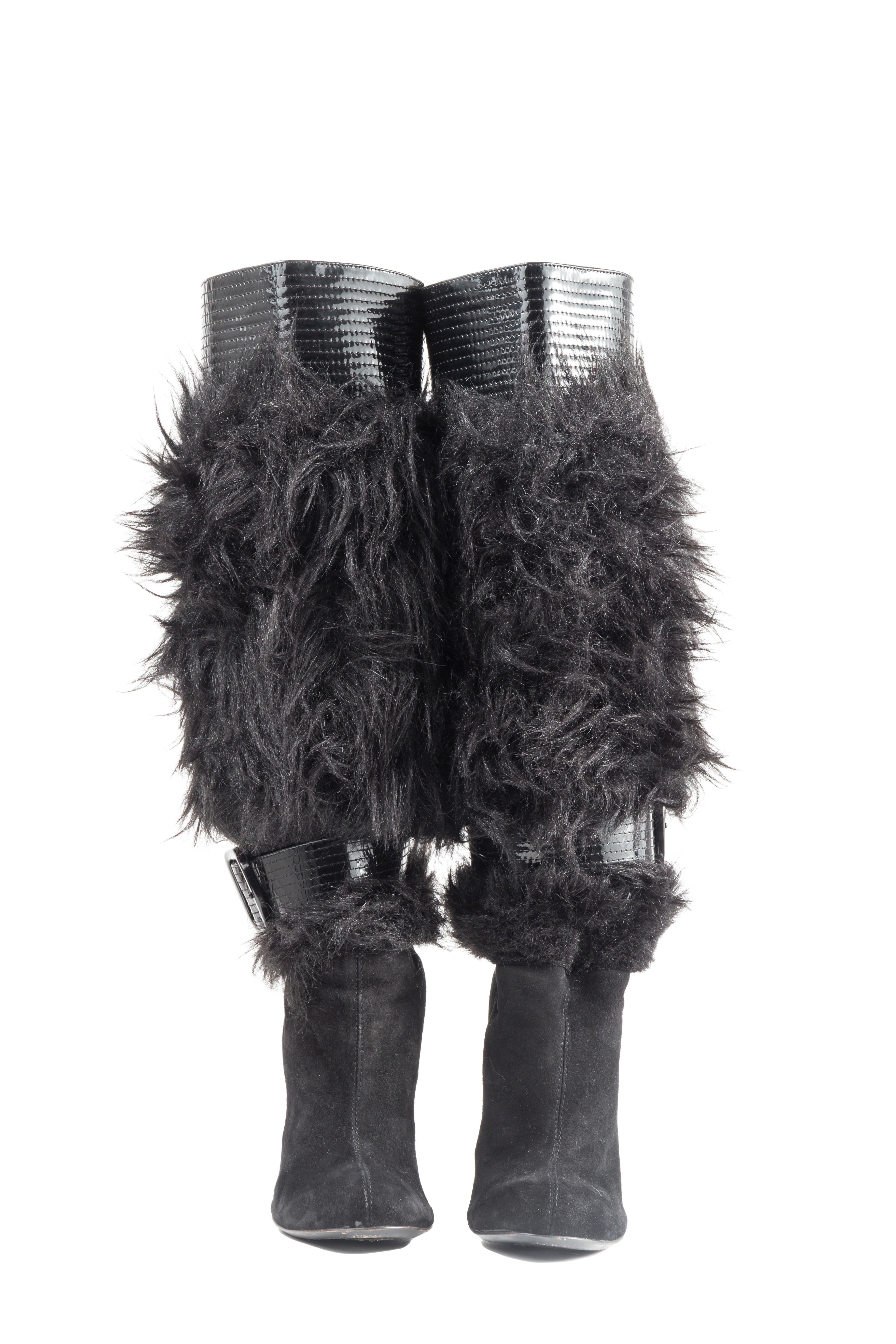 - “Galliano” by John Galliano calf length boots
- Sold by Gold Palms Vintage
- Mid 2000s
- Black suede vamp and heels
- Faux fur shaft
- Vinyl quilted trim and belt
- Comes with its original dust bag
- Size 40 / US 9
