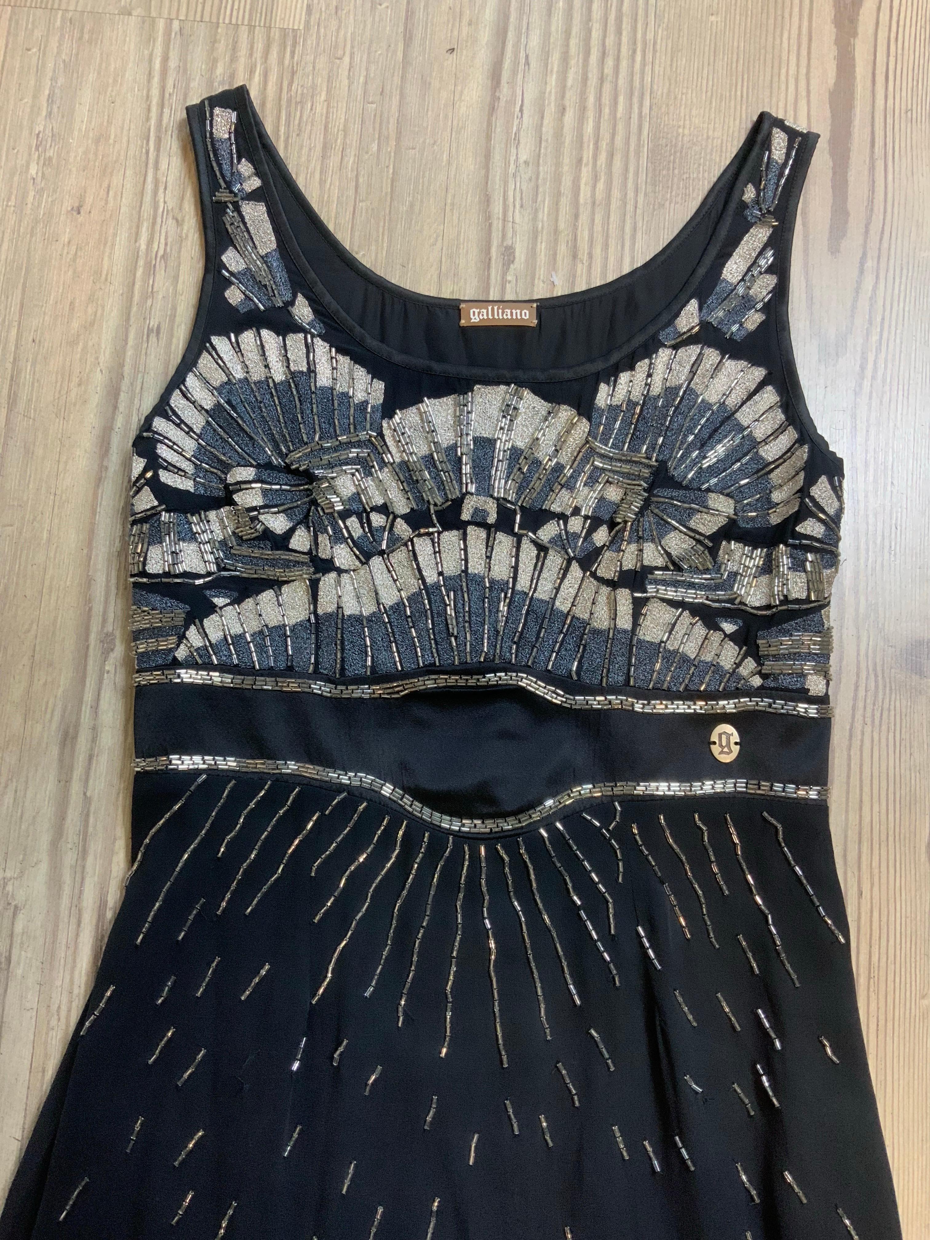 Galliano mini dress.
In black silk with sequins details.
Side zip closure.
Italian size 40.
Bust 38 cm
Waist 35cm
Length 94 cm
Good general condition, shows signs of normal use. It has some pulled threads and is missing some sequins.