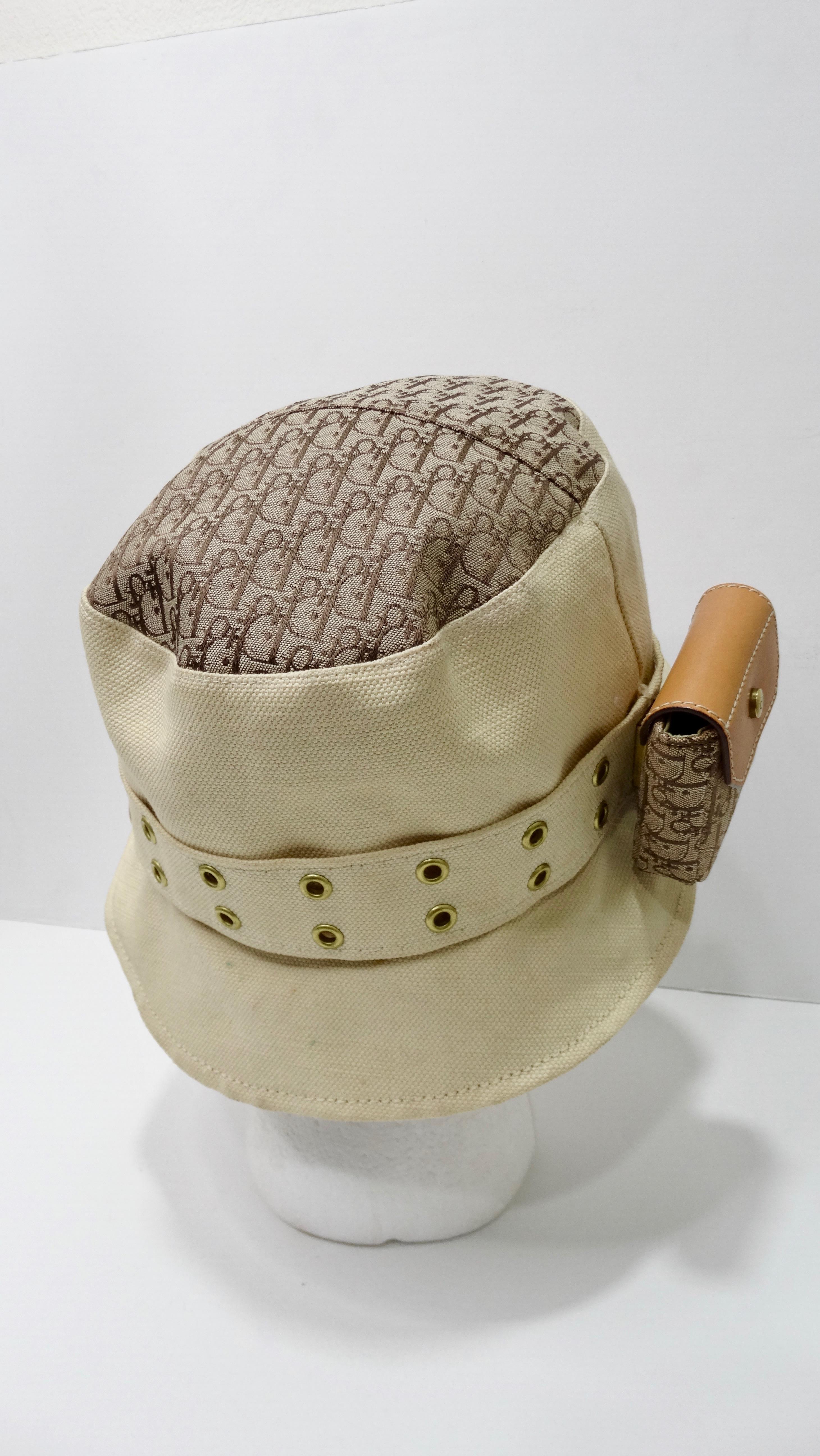 Complete your dream street wear look with this amazing Galliano for Dior bucket hat! Circa 2002 from their Spring collection, this two-tone canvas bucket hat features the classic Dior monogram, a grommet studded band adorned with a leather and