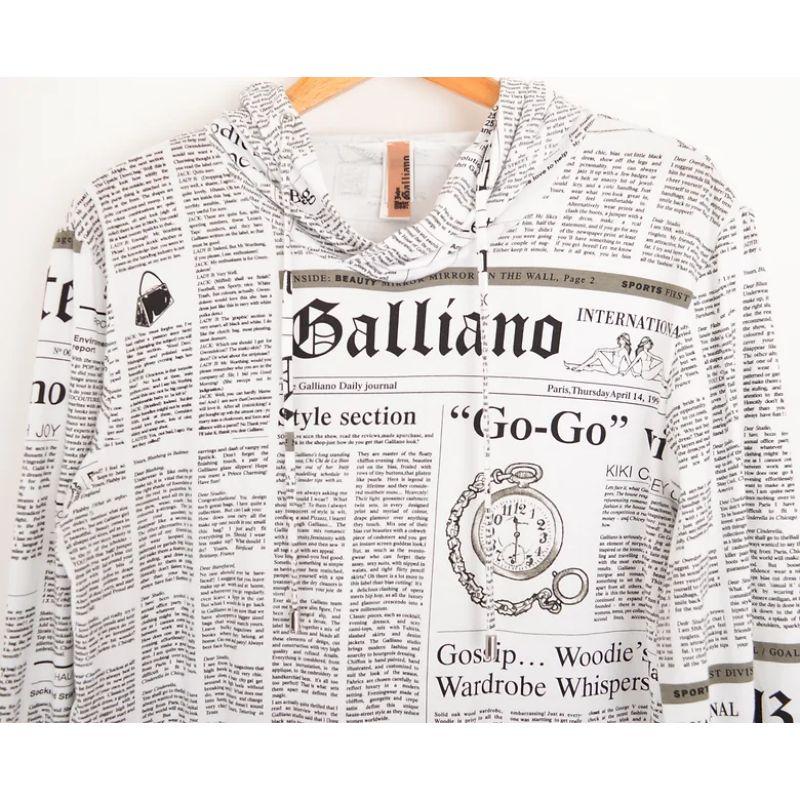 John Galliano iconic Newspaper print hooded sweatshirt. 

Features:
Drawstring hood
Slouchy front pocket
Adjustable drawstring waistline
Lond sleeves
95% Cotton / 5% Spandex
Sizing: Pit to Pit: 21''
Pit to Cuff: 21''
Nape to Hem: 27''
Recommended