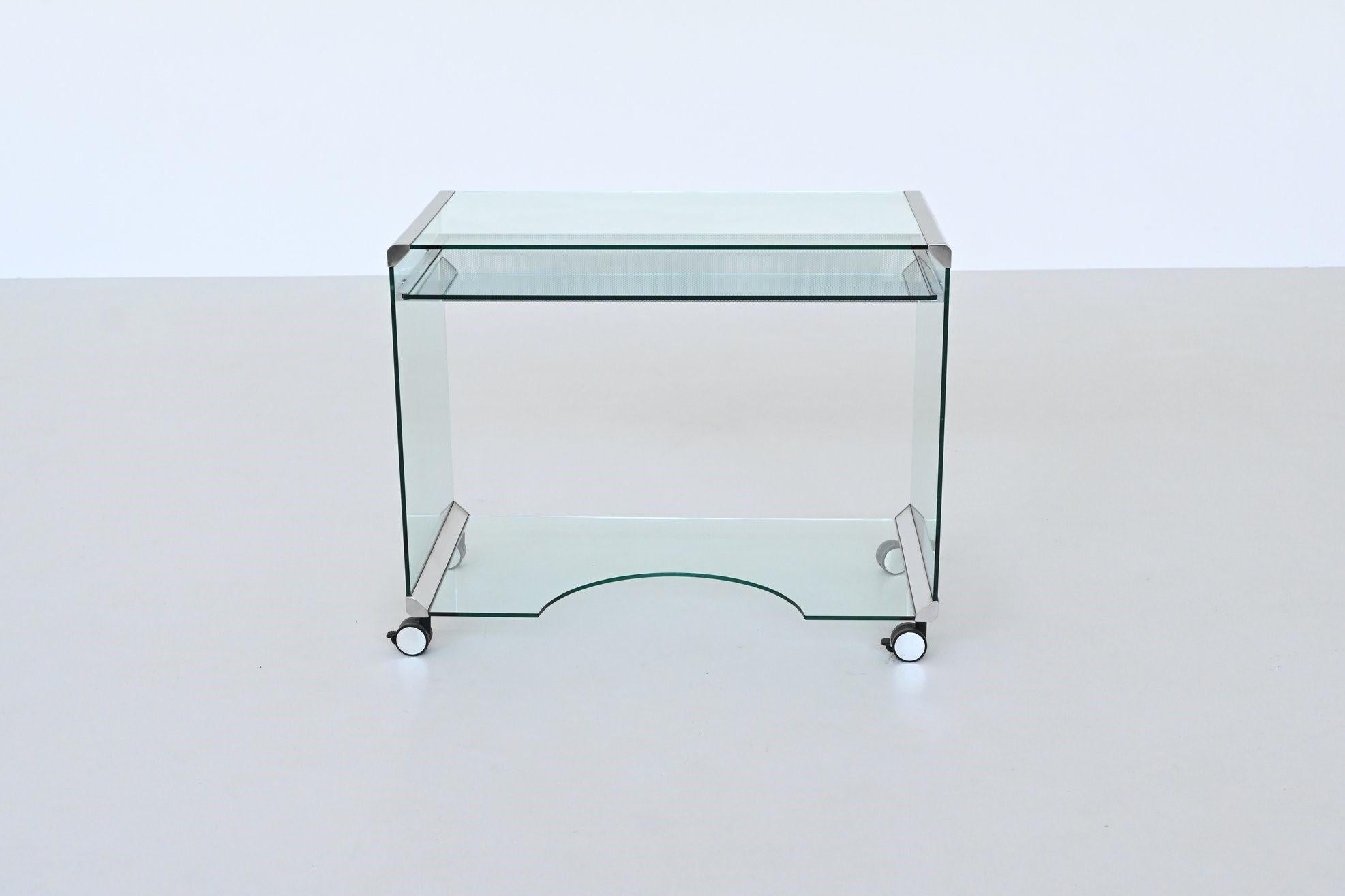 Beautiful “Movie Office – Computer Desk” designed and manufactured by Gallotti & Radice, Italy 1970. A unique glass desk on castors with an ergonomic cutout in the base ensures good leg room. The castors make this glass table is ideal for use with a