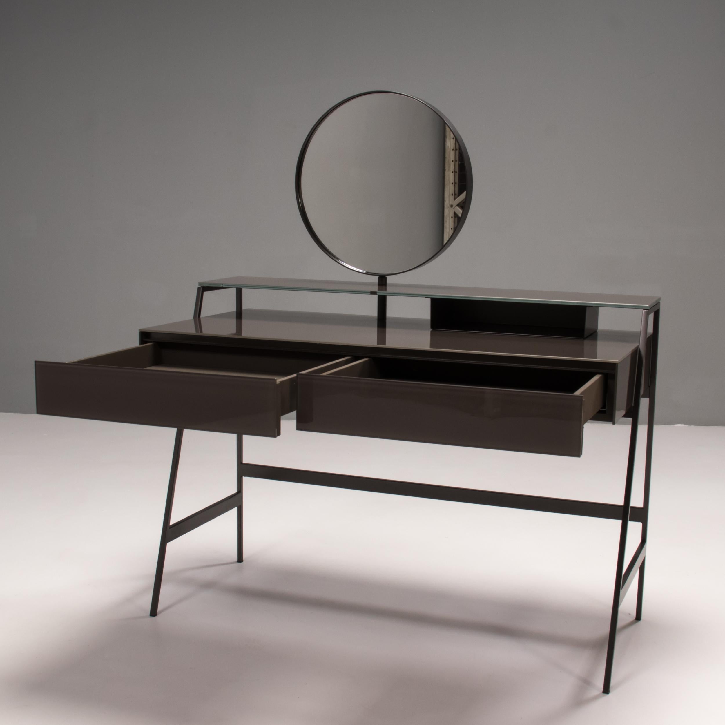 Designed by Carlo Colombo for Gallotti & Radice in 2013, the Venere vanity desk is an incredibly versatile piece of modern design.

Constructed from solid wood with a painted glass finish and a burnished metal frame, the vanity features a shelf