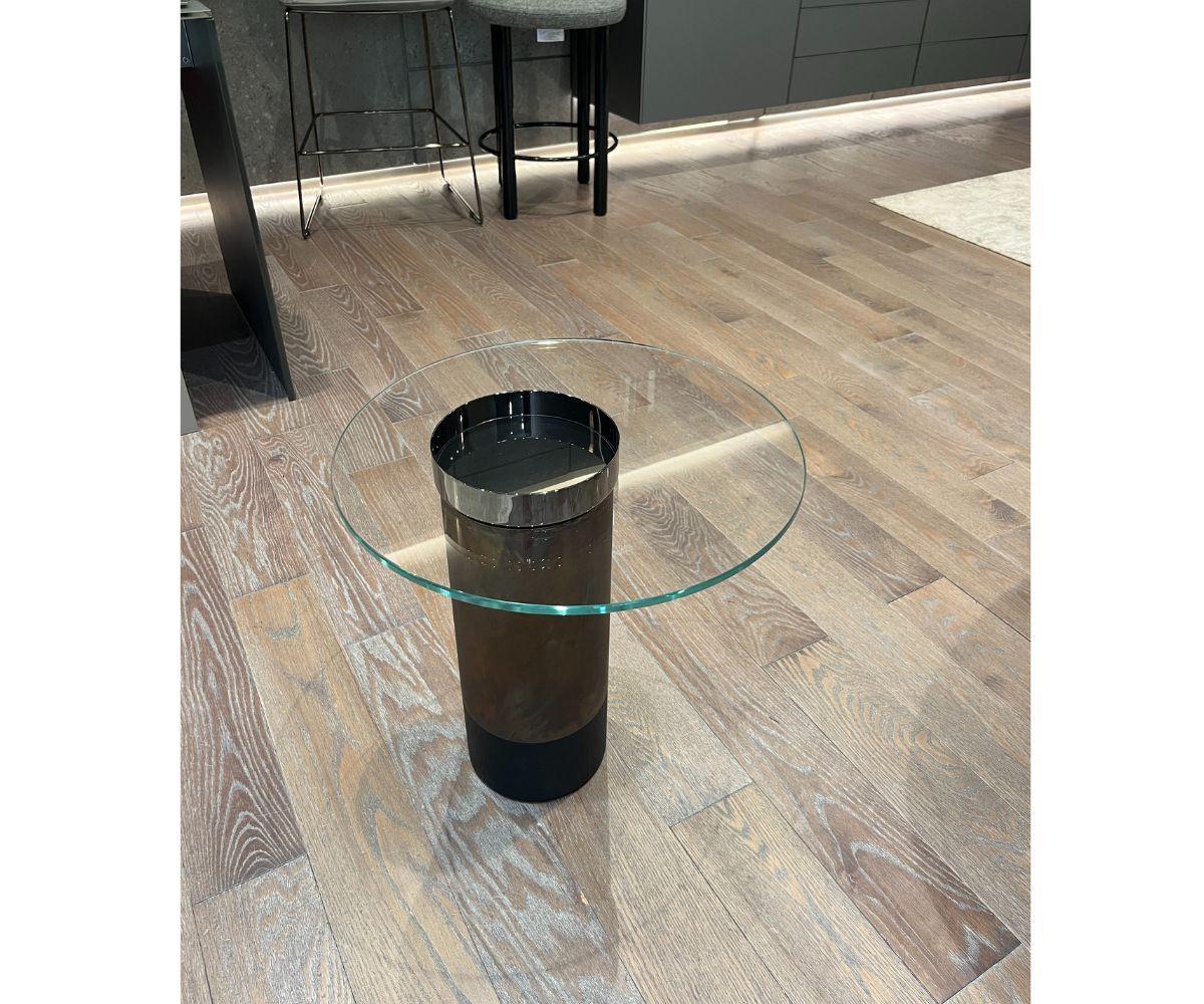 Der Beistelltisch Haumea von Gallotti&Radice, entworfen von Massimo Castagna, ist ein raffiniertes und modernes Stück. Die Tischplatte besteht aus 10 mm dickem, transparentem, extra hellem, gehärtetem Glas und wird von einem schwarzen, offenporigen