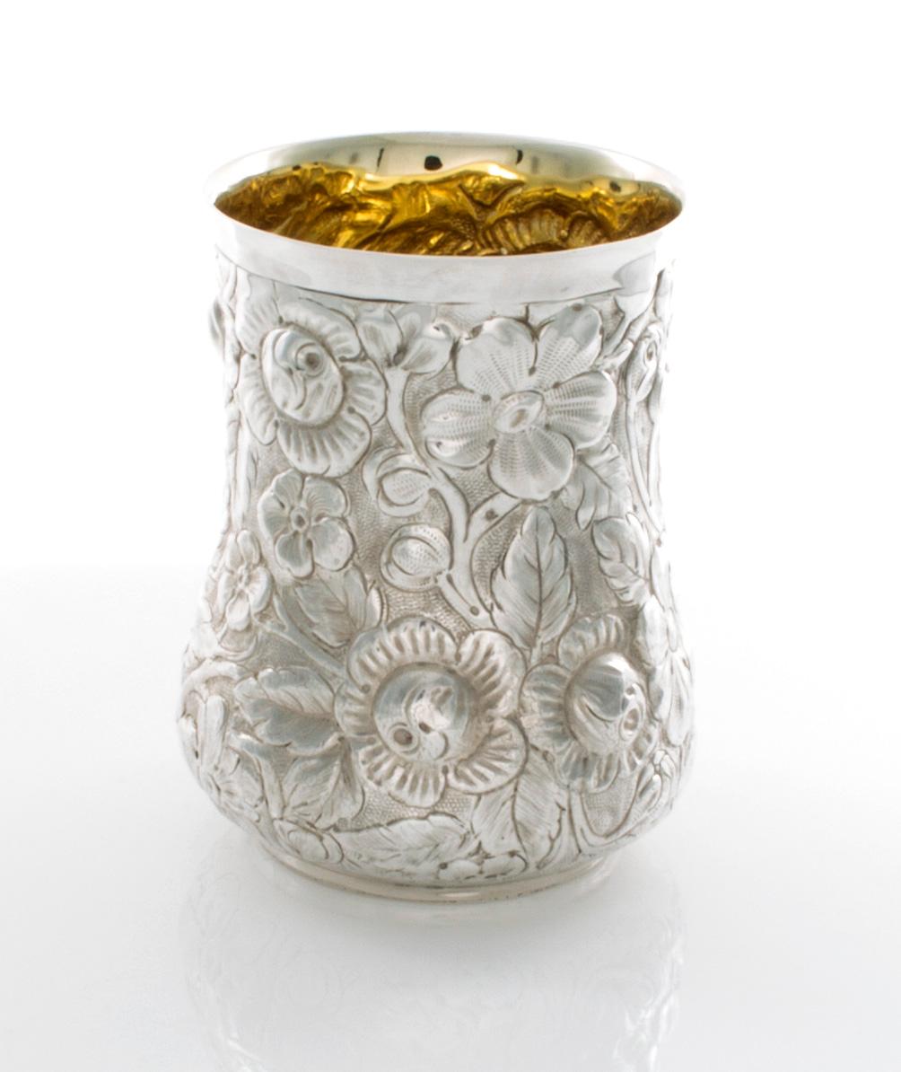 This is a set of six Galmer sterling silver mint juleps with a gold wash on the inside. The have a design of repoussé flowers that are extremely detailed. They are approximately 4 1/8