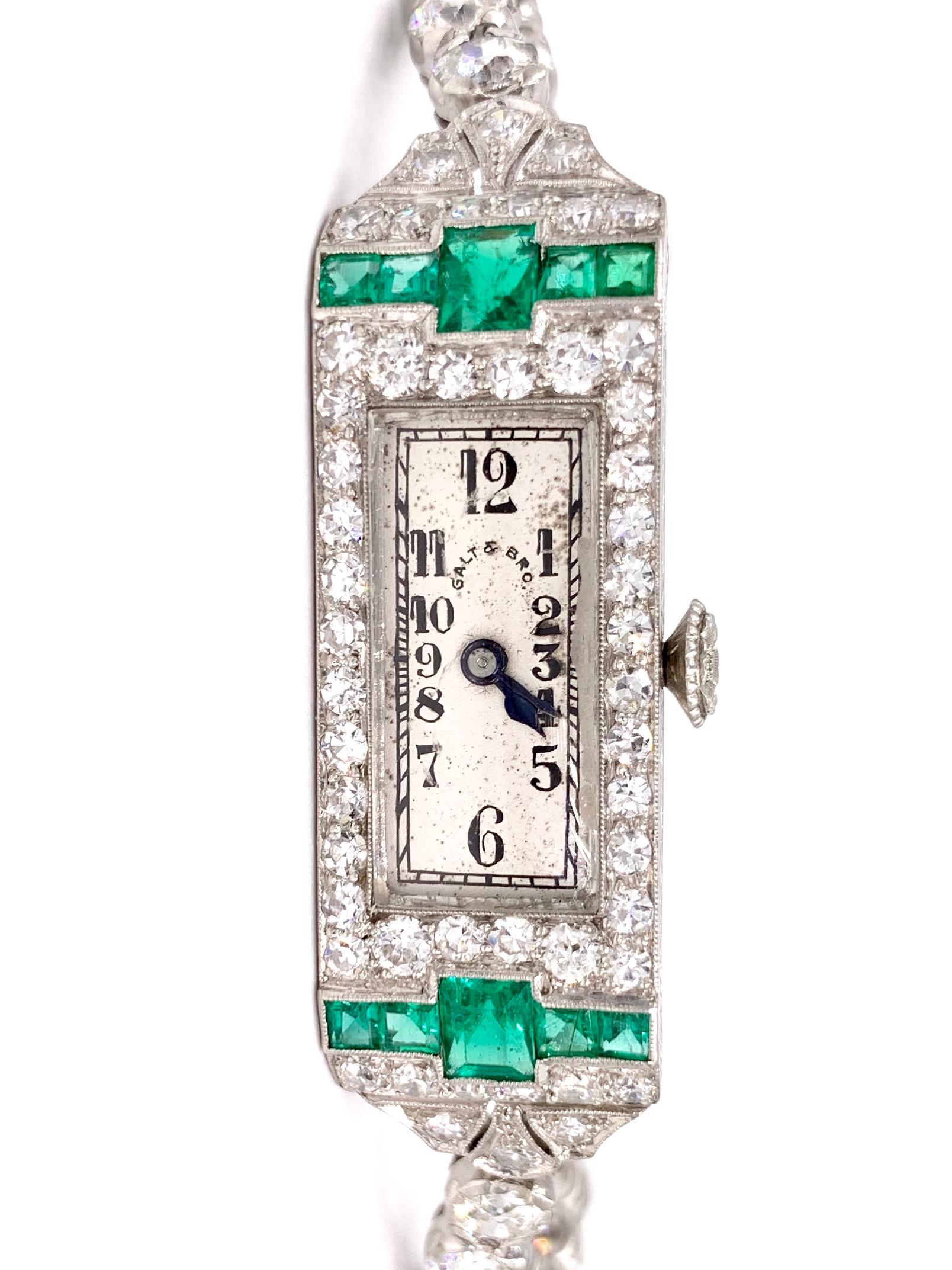 Elegant and beautifully detailed antique platinum emerald and diamond Galt & Brothers watch with a Swiss made Patek Philippe manual movement on a gorgeous European cut diamond tennis style bracelet. Patek Philippe & Co. movement is signed with the