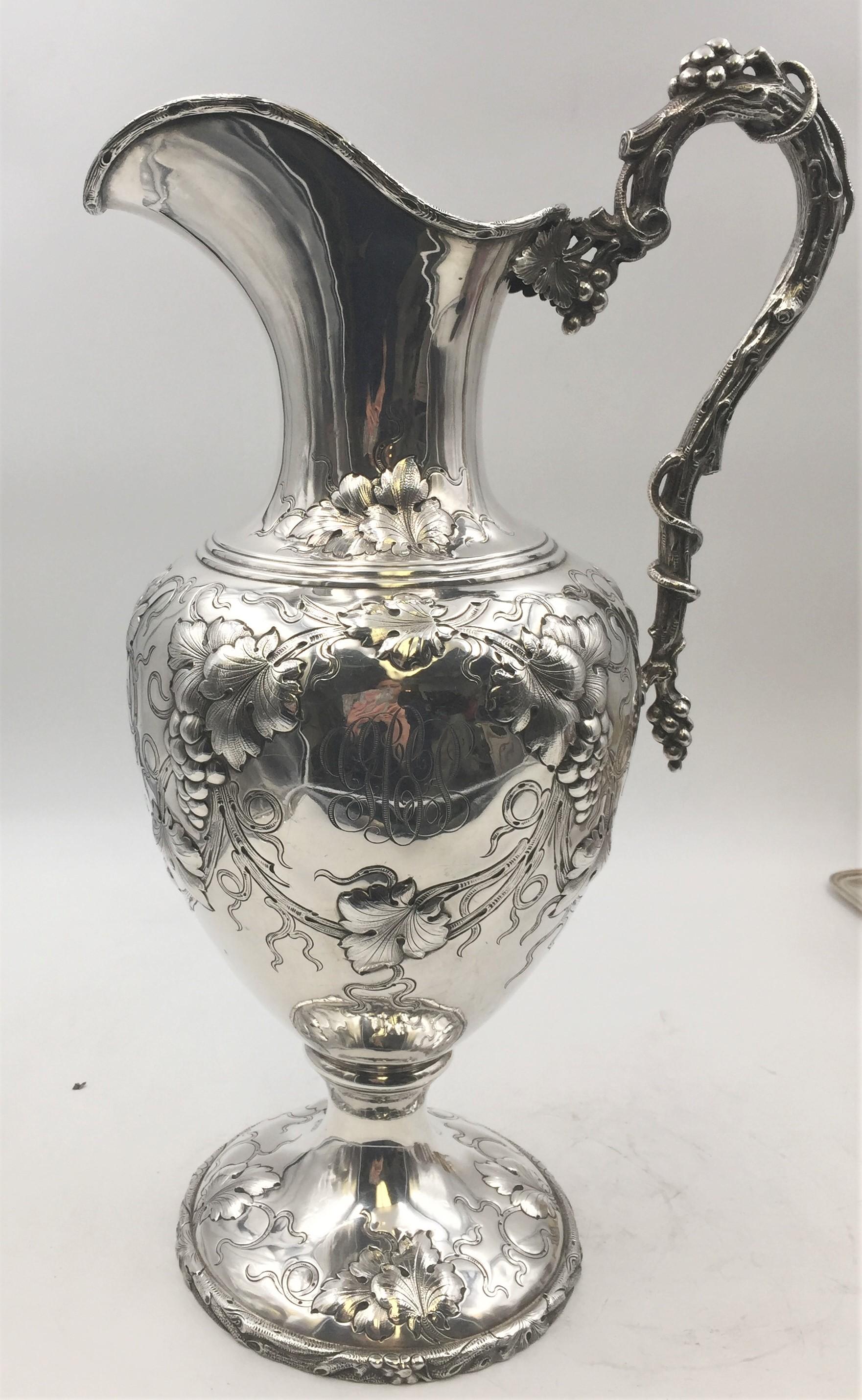 One of a kind and extraordinary sterling silver ewer, monumental in size by Galt Brothers, circa 1910. Body of the ewer designed in high shoulder baluster form, decorated with grape clusters , leaves, and vines in beautiful relief. Handle designed